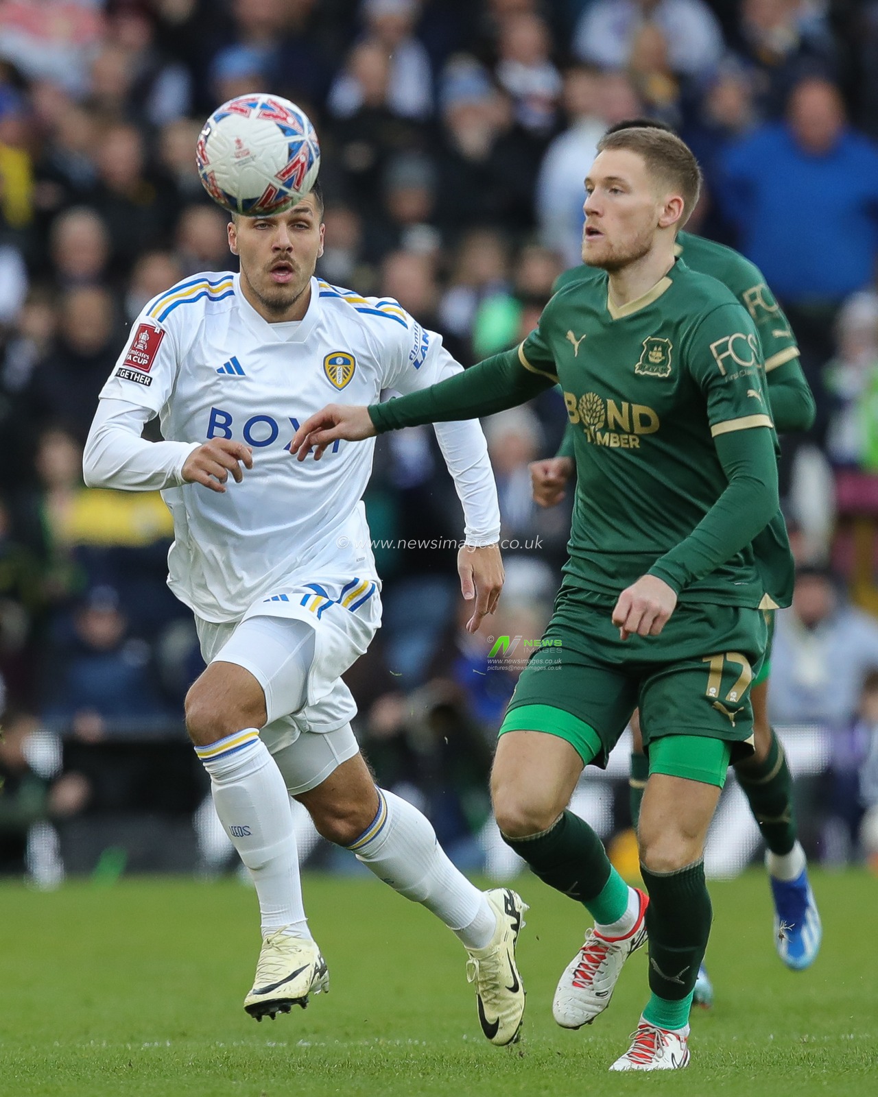JoÃ«l Piroe of Leeds United and Lewis Gibson of Plymouth Argyle battle for the ball during the Emirates FA Cup  Fourth Round match Leeds United vs Plymouth Argyle at Elland Road, Leeds, United Kingdom, 27th January 2024

(Photo by James Heaton/News Images)