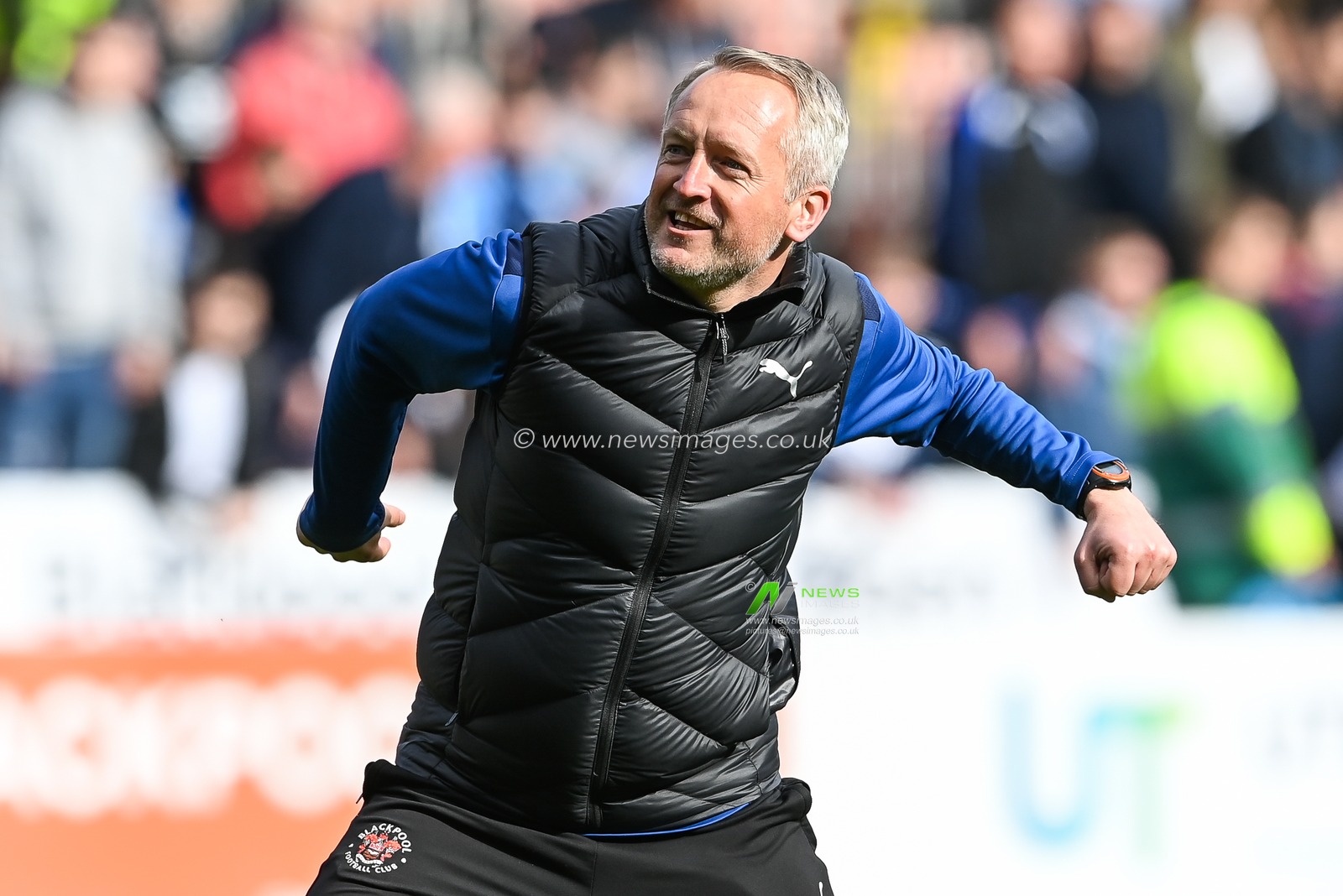 Neil Critchley manager of Blackpool celebrates his sides win with the fans
