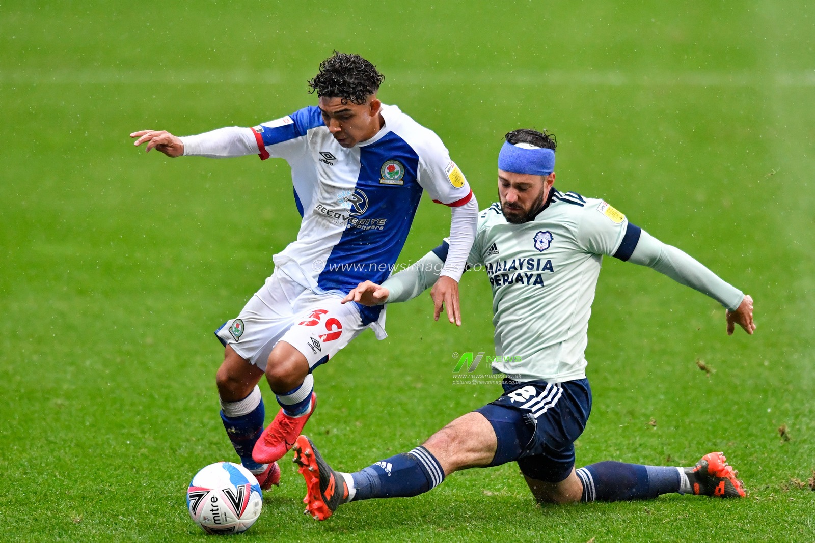 Greg Cunningham (18) of Cardiff City attempts to win the ball from Tyrhys Dolan (39) of Blackburn Rovers with a sliding tackle