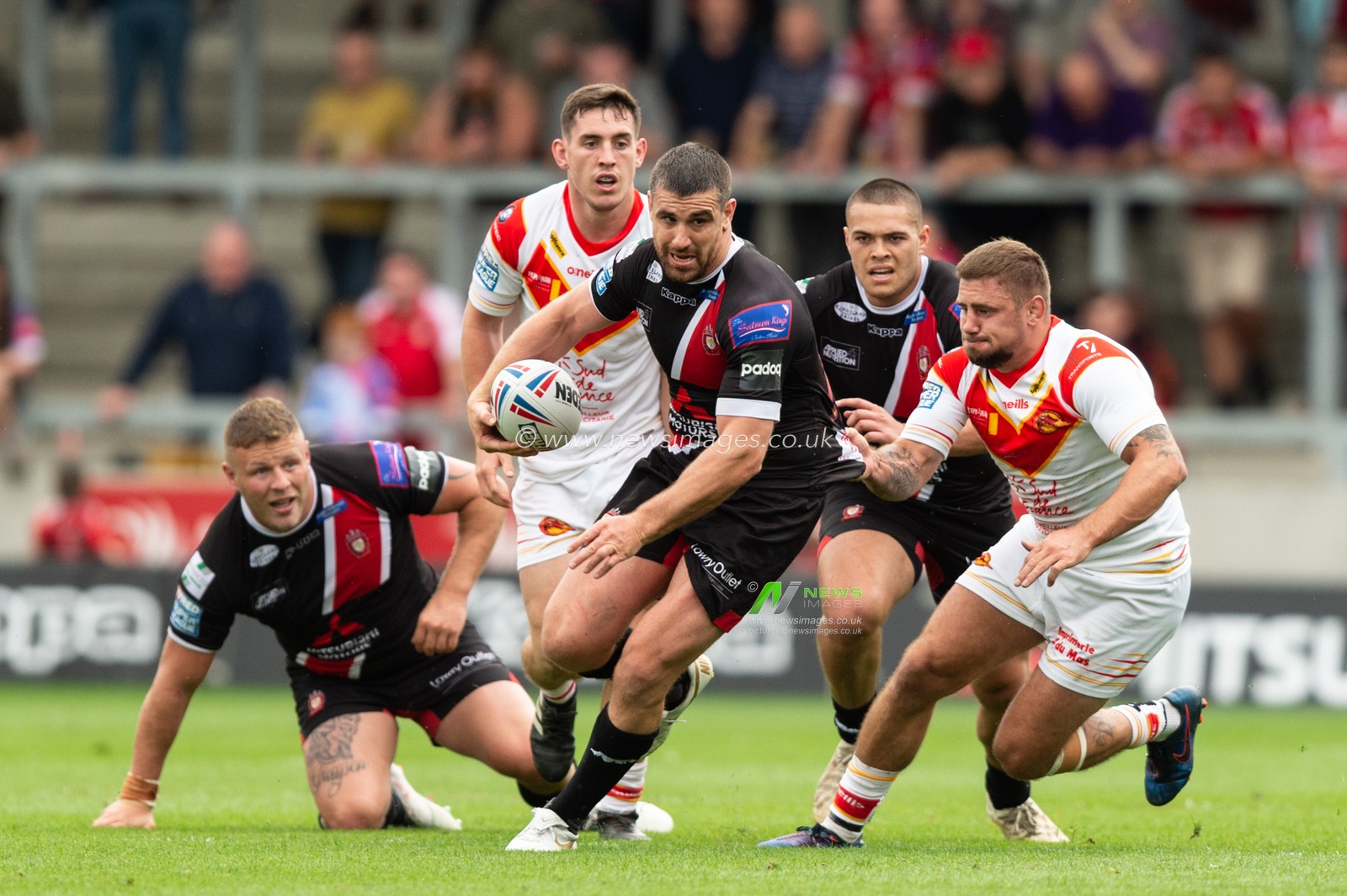 21st July 2019 ,  AJ Bell Stadium, Salford, England;  Betfred Super League, Round 23, Salford Red Devils vs Catalans Dragons ; Tyrone McCarthy of Salford Red Devils makes a break away from Michael Mcilorum (9) of Catalans Dragons 

Credit: Richard Long/News Images