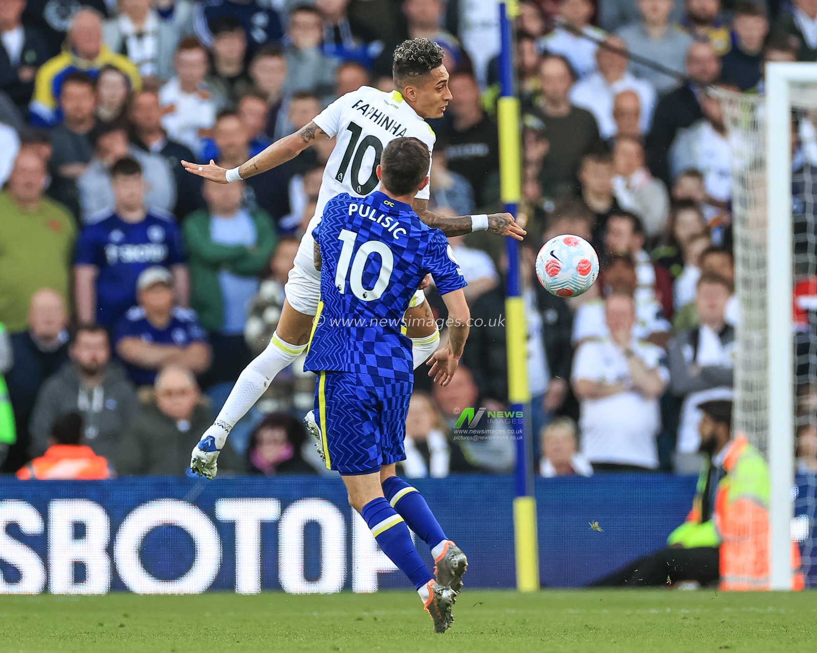 Raphinha #10 of Leeds United heads clear under pressure from Christian Pulisic #10 of Chelsea