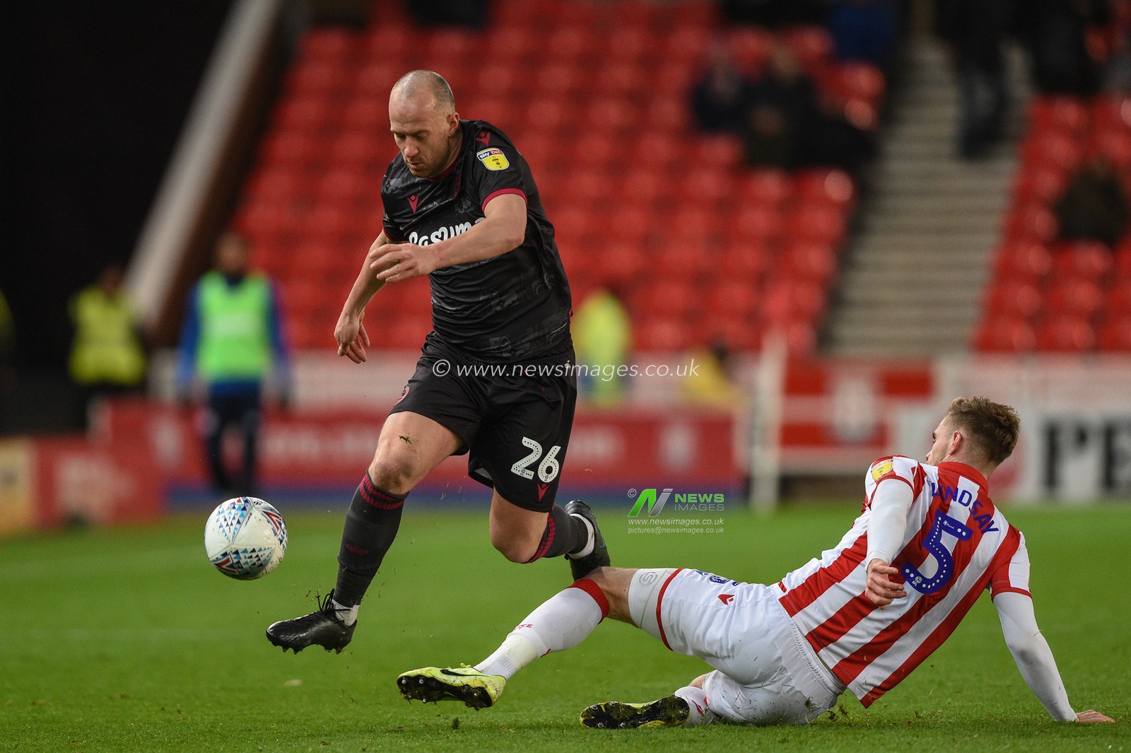 14th December 2019, Bet365 Stadium, Stoke-on-Trent, England; Sky Bet Championship, Stoke City v Reading : Charlie Adam (26) of Reading is tackled by Liam Lindsay (5) of Stoke City 

Credit: Richard Long/News Images