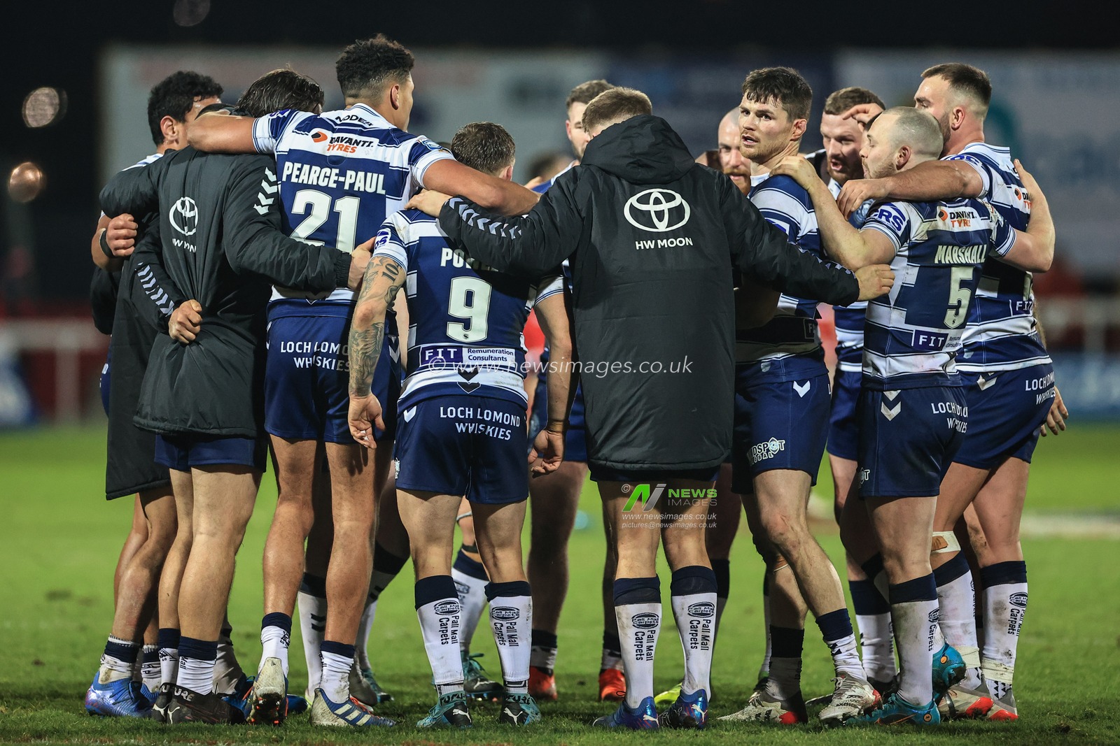Wigan have a group huddle after winning the game