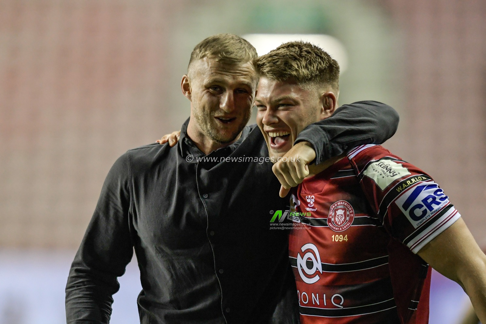 Dom Manfredi of Wigan Warriors shares a joke with Morgan Smithies (15) of Wigan Warriors after the final whistle