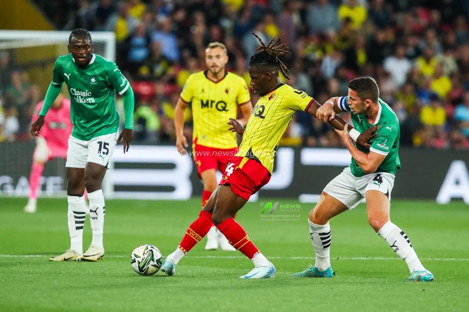 Tom Dele-Bashiru of Watford battles for the ball with Jordan Houghton of Plymouth Argyle during the Carabao Cup match Watford vs Plymouth Argyle at Vicarage Road, Watford, United Kingdom, 27th August 2024

(Photo by Izzy Poles/News Images)