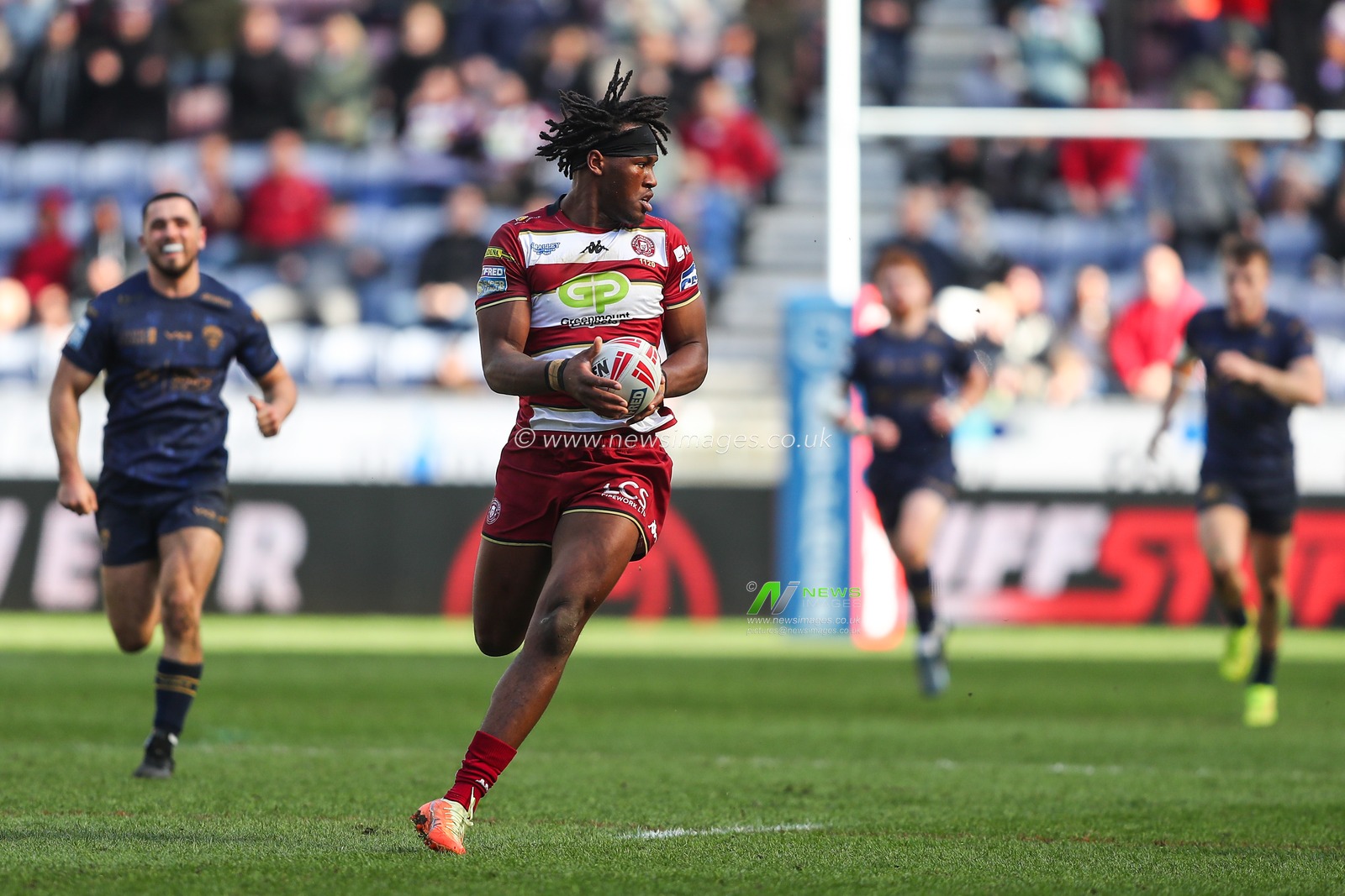 Junior Nsemba of Wigan Warriors breaks with the ball during the Betfred Super League Round 6 match Wigan Warriors vs Salford Red Devils at The Brick Community Stadium, Wigan, United Kingdom, 30th March 2025

(Photo by Gareth Evans/News Images)