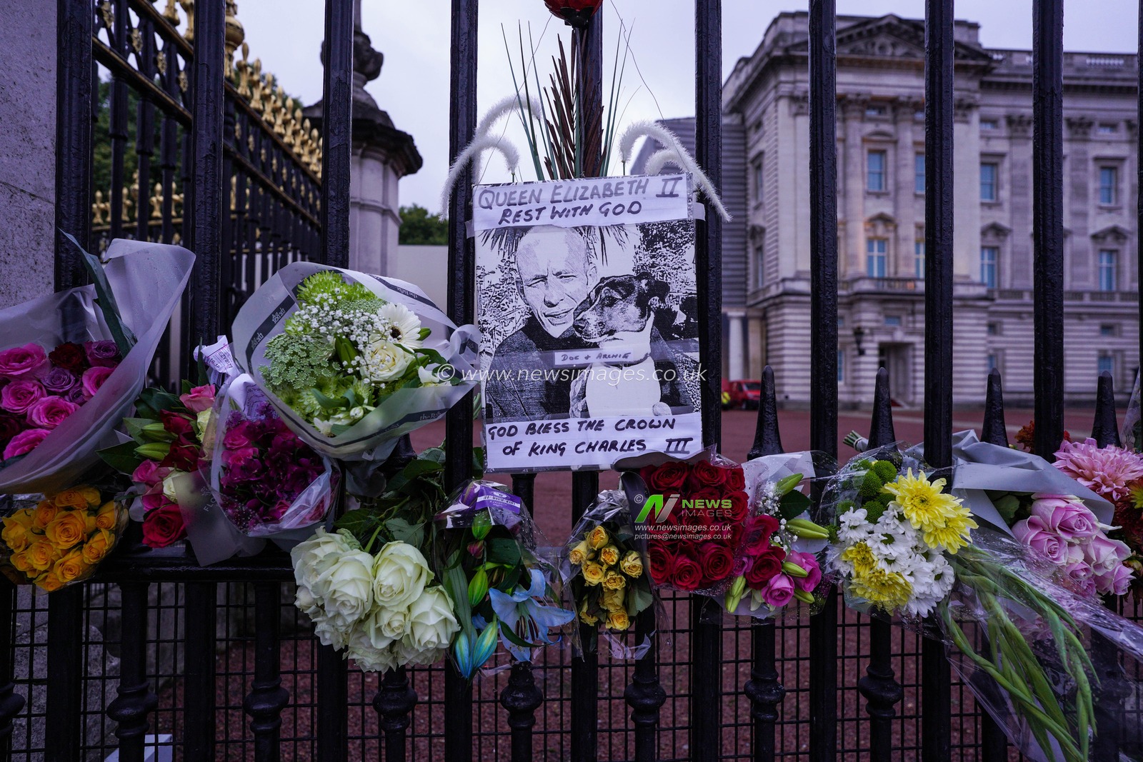 A sign saying â€œ Queen Elizabeth II Rest With God â€œ is displayed on the Palace gates as mourners pay their respects after the passing of Her Majesty The Queen at Buckingham Palace, London, United Kingdom, 9th September 2022

(Photo by Richard Washbrooke/News Images)