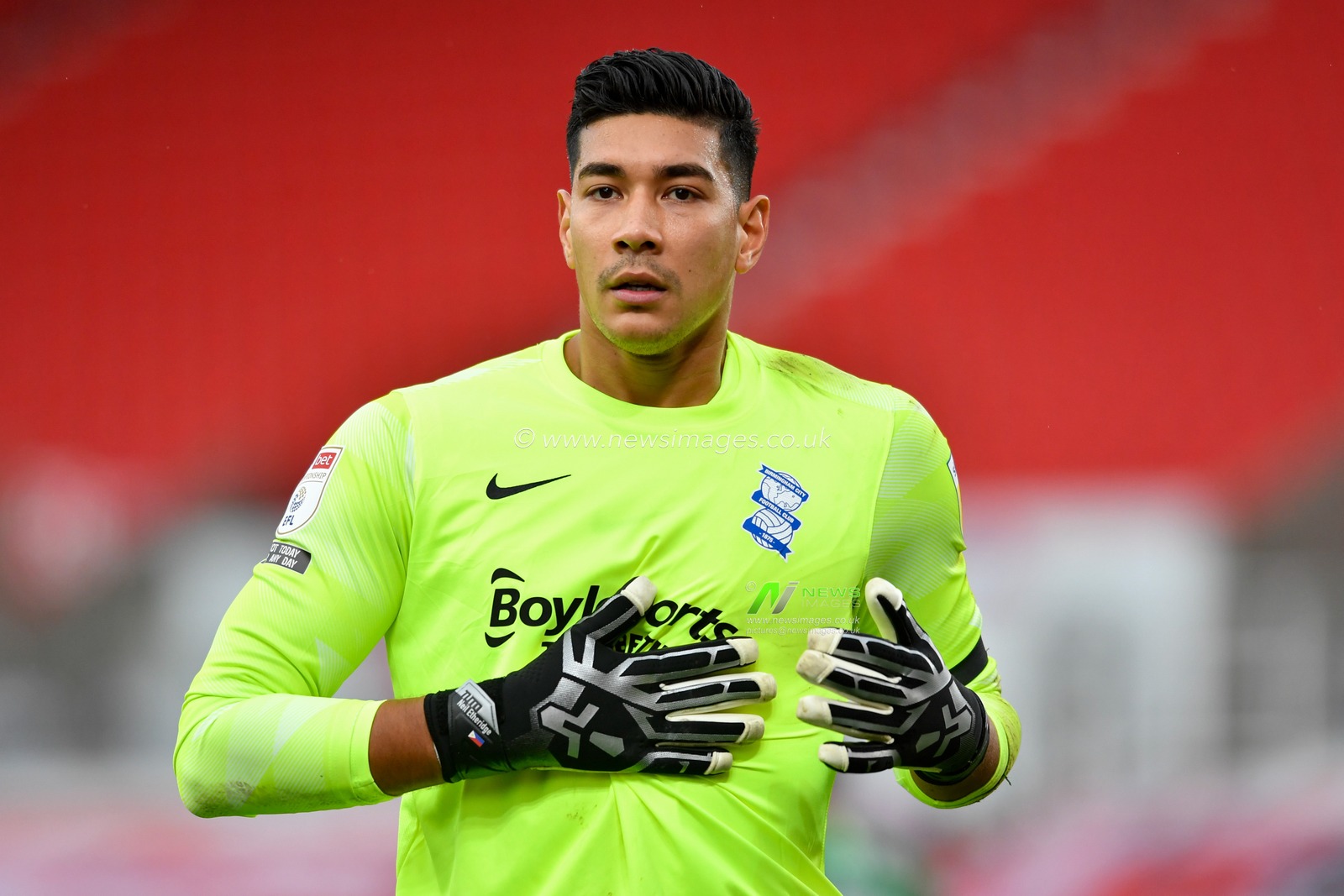 Neil Etheridge (30) of Birmingham City wipes his gloves on his shirt during the game