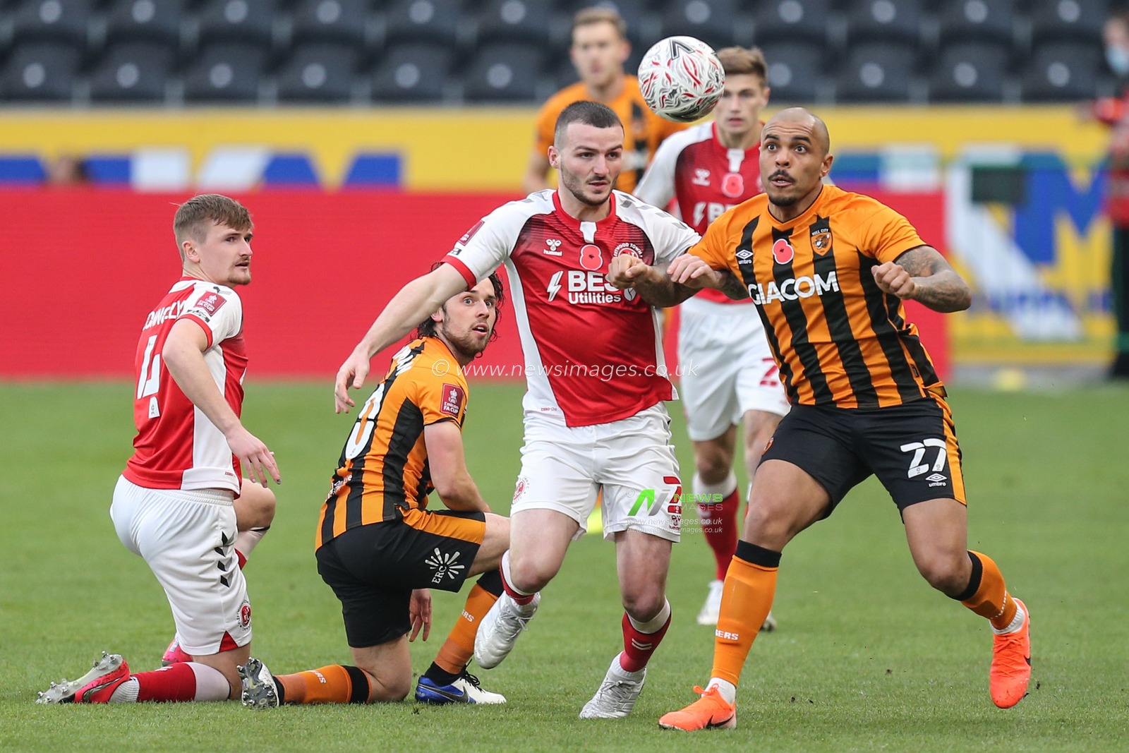 Josh Magennis #27 of Hull City and Tom Edwards #2 of Fleetwood Town challenge for the ball