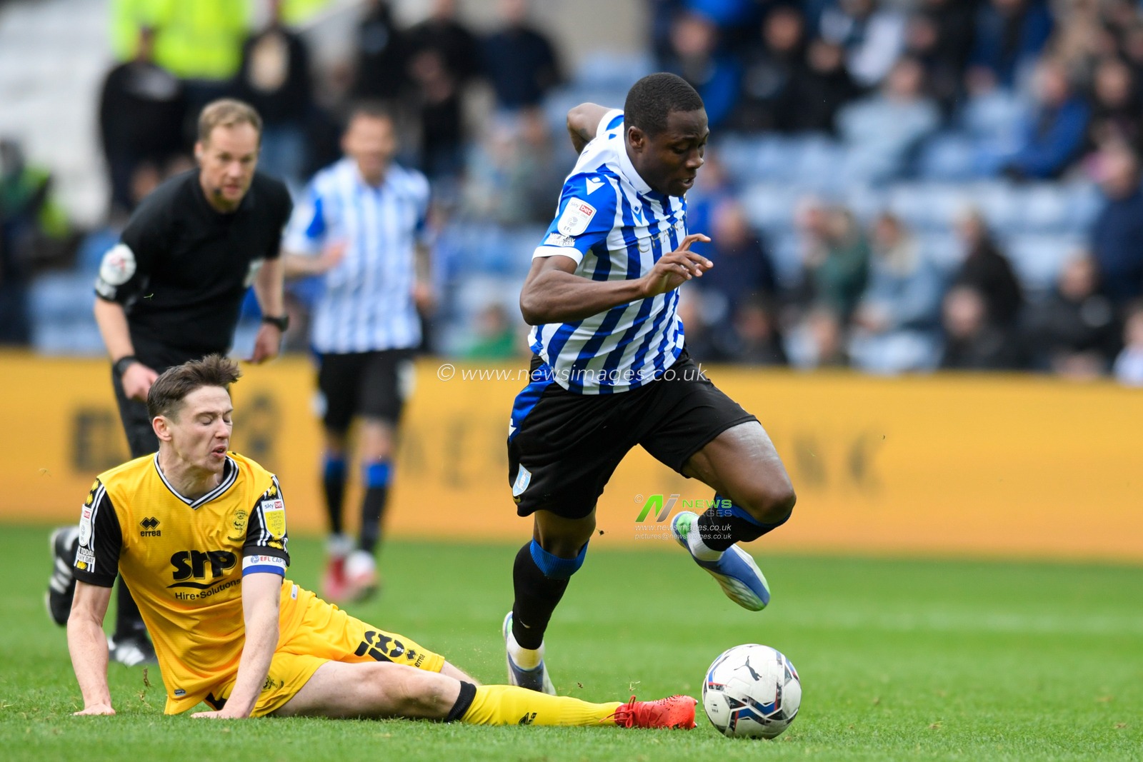 Dennis Adeniran #8 of Sheffield Wednesday is fouled by Conor McGrandles #18 of Lincoln City