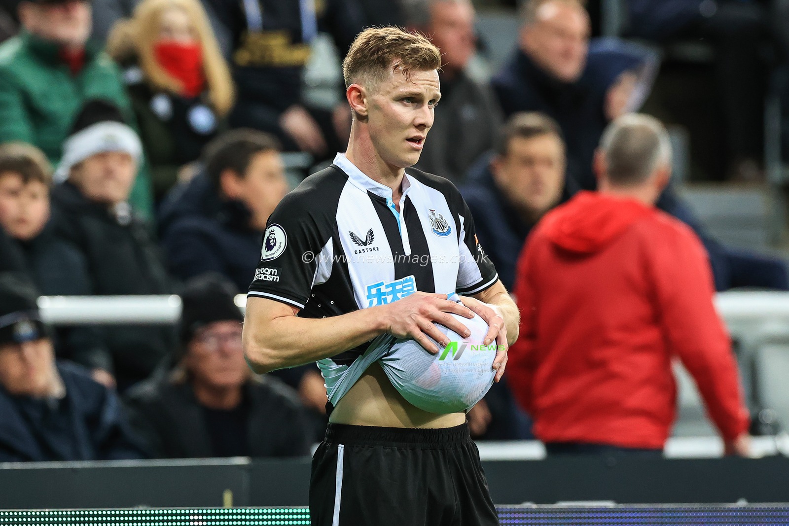 Emil Krafth #17 of Newcastle United wipes the ball before he takes a throw in