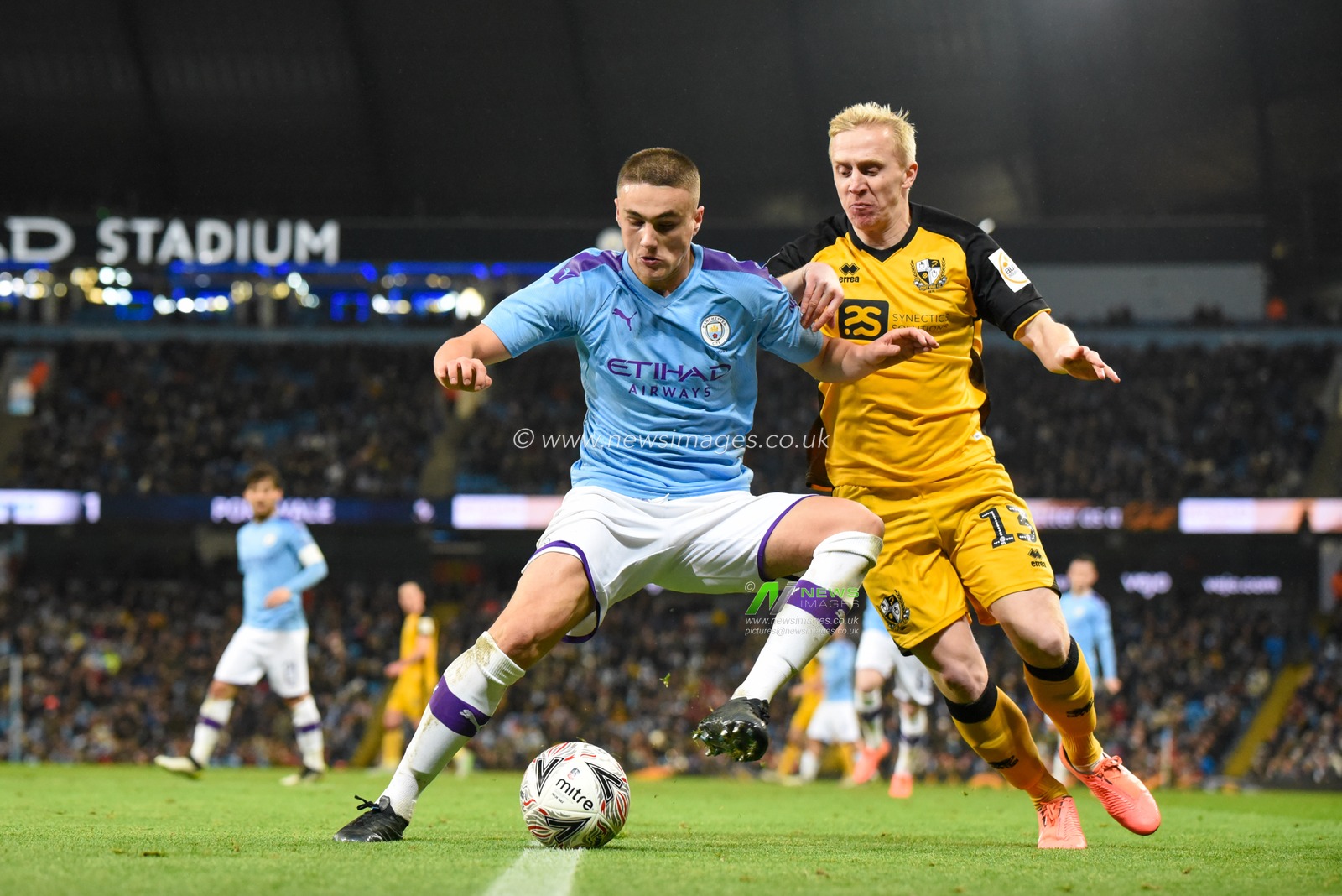 4th January 2020, Etihad Stadium, Manchester, England; Emirates FA Cup, Manchester City v Port Vale : Taylor Harwood-Bellis (78) of Manchester City holds off the challenge from Mark Cullen (13) of Port Vale

Credit: Simon Whitehead/News Images