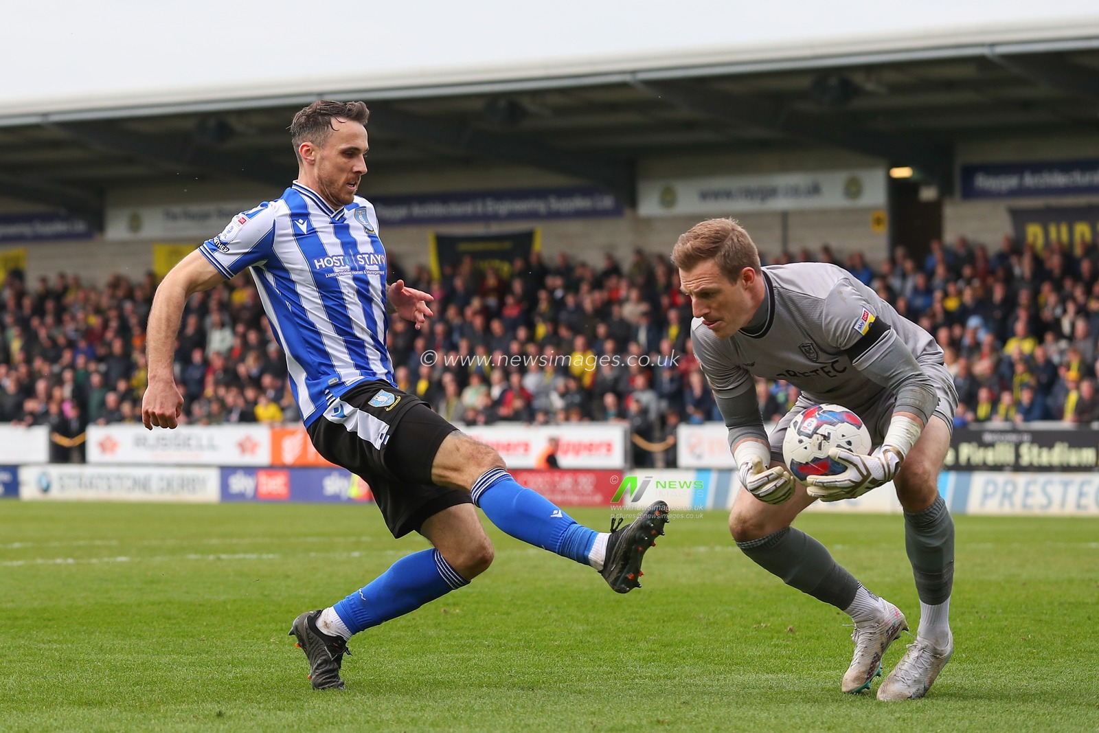 Lee Gregory #9 of Sheffield Wednesday chases down Craig MacGillivray #34 of Burton Albion during the Sky Bet League 1 match Burton Albion vs Sheffield Wednesday at Pirelli Stadium, Burton upon Trent, United Kingdom, 15th April 2023

(Photo by Gareth Evans/News Images)