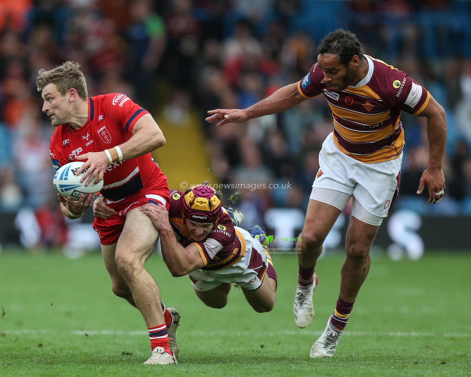 Jimmy Keinhorst #18 of Hull KR is tackled by Theo Fages #7 of Huddersfield Giants