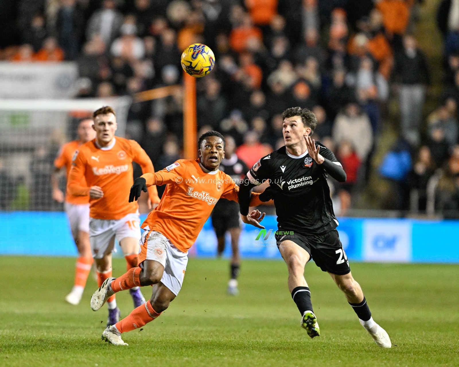 Karamoko DembÃ©lÃ© of Blackpool and Calvin Ramsay of Bolton battle for the ball, during the Bristol Street Motors Trophy Quarter Final match Blackpool vs Bolton Wanderers at Bloomfield Road, Blackpool, United Kingdom, 30th January 2024

(Photo by Cody Froggatt/News Images)