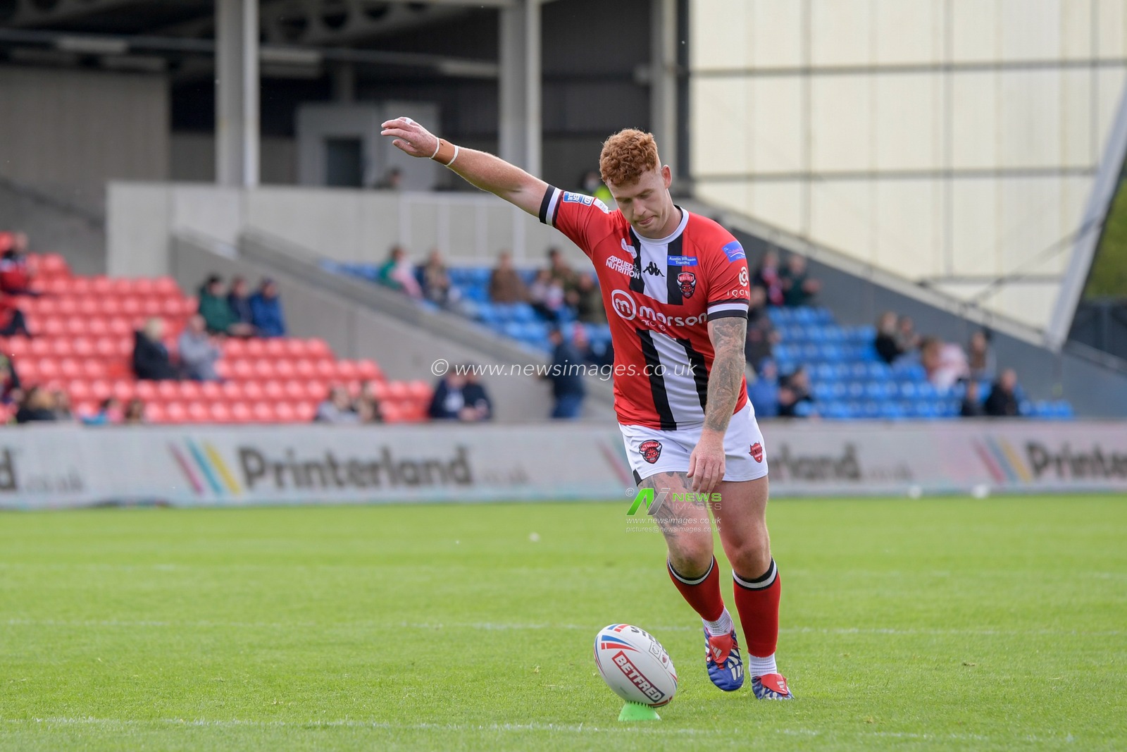 Harvey Livett (20) of Salford Red Devils successfully kicks a conversion to make it 12-6