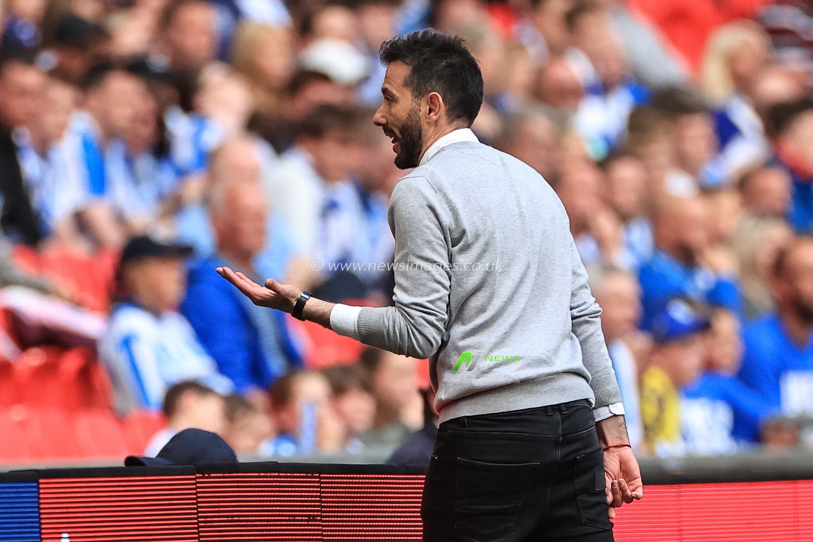 Carlos CorberÃ¡n manager of Huddersfield Town shouts instructions back to his bench