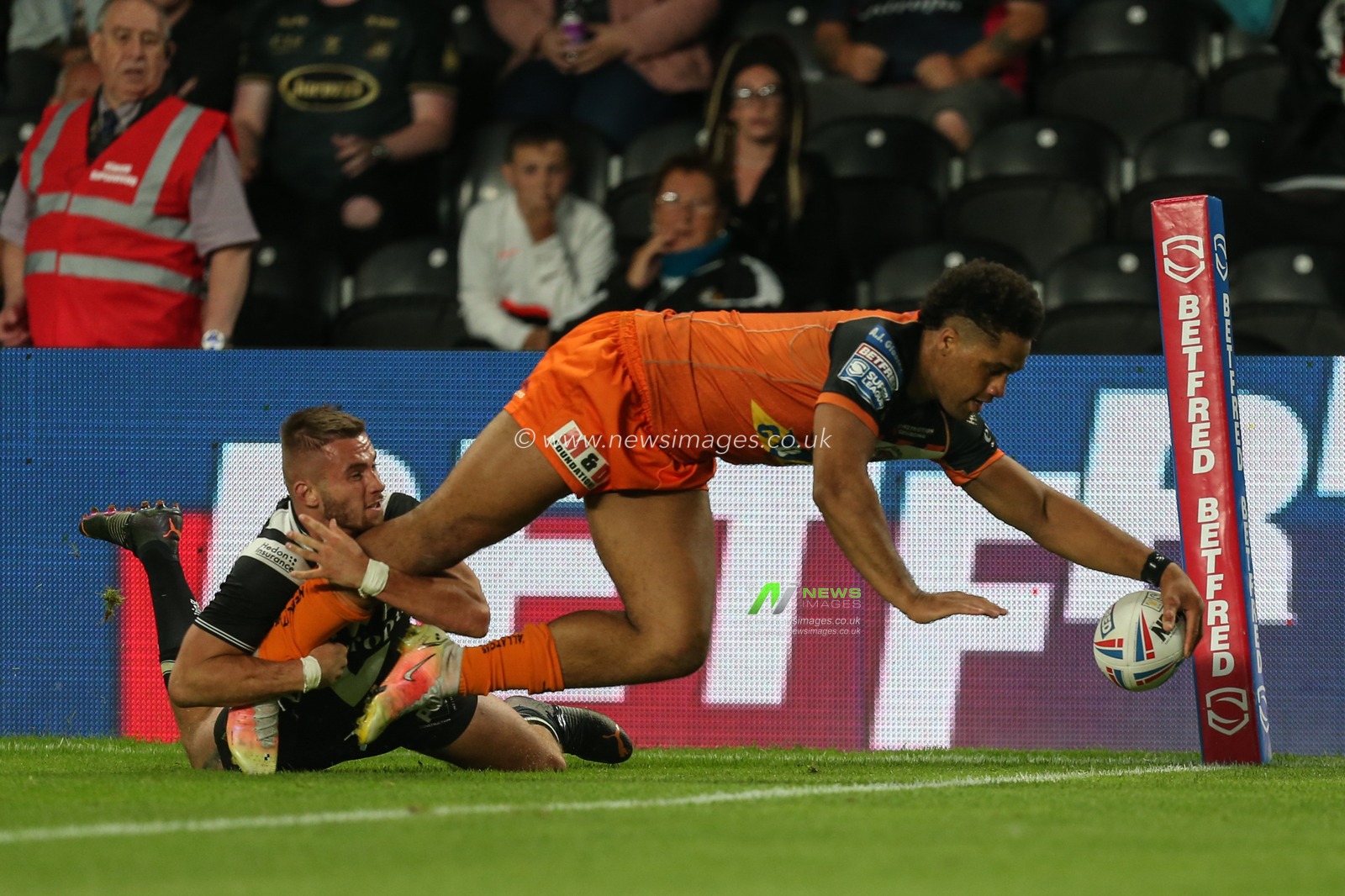 Derrell Olpherts #2 of Castleford Tigers runs to the try line to complete his hat-trick of tries