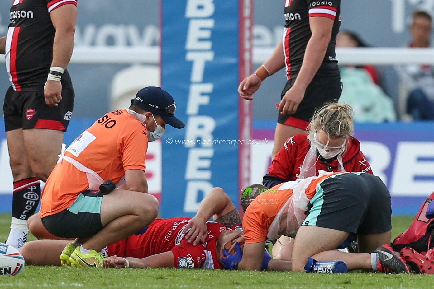 Dean Hadley (13) of Hull KR lies on the pitch receiving medical attention