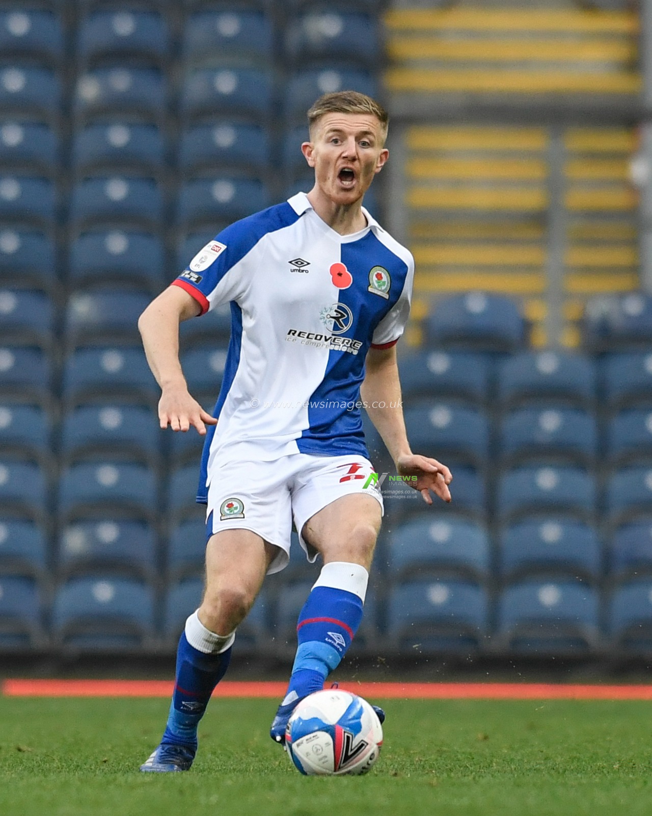 Scott Wharton #28 of Blackburn Rovers passes the ball