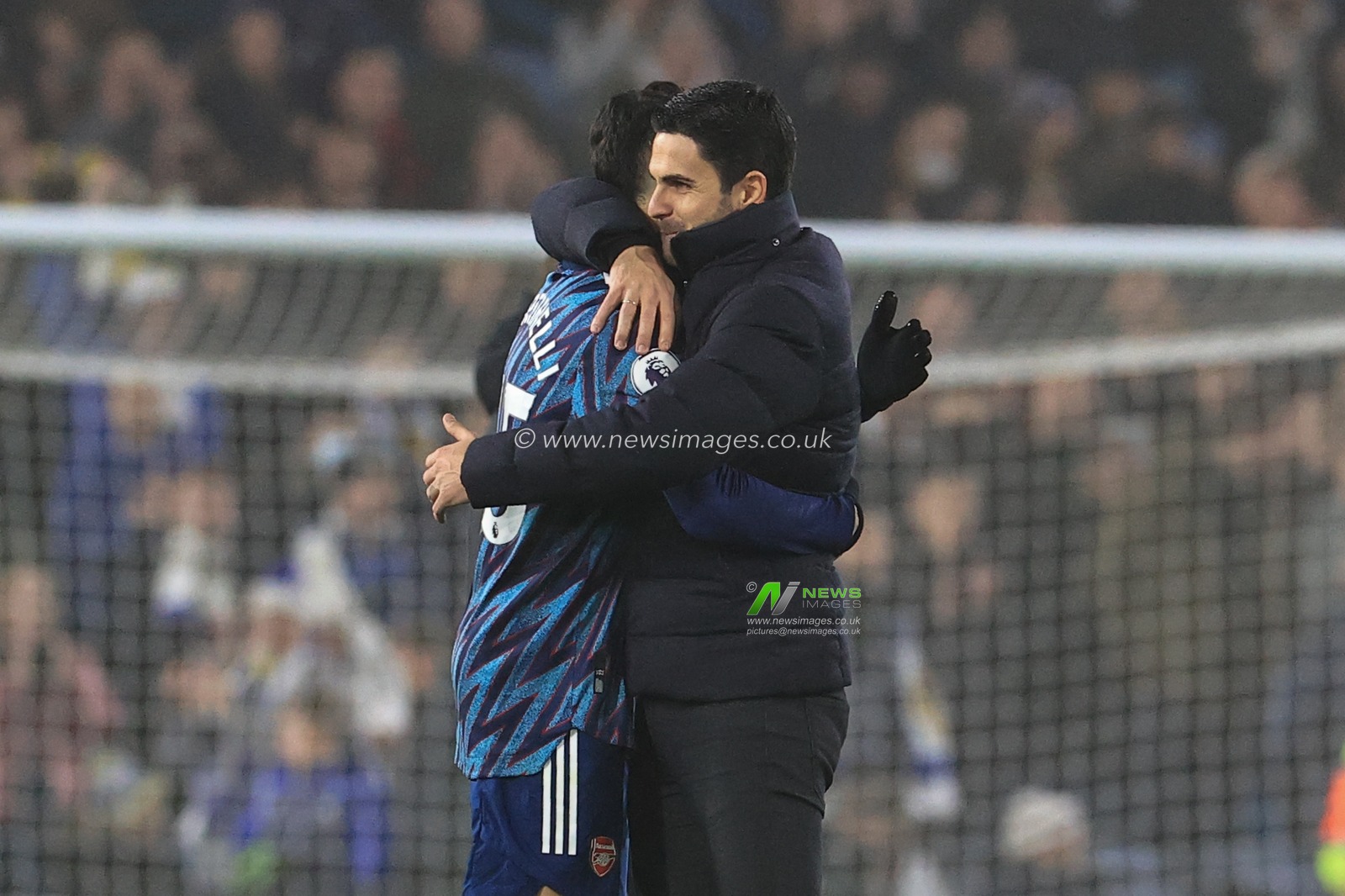 Mikel Arteta manager of Arsenal and Gabriel Martinelli #35 of Arsenal embrace each other after Arsenal win 1-4
