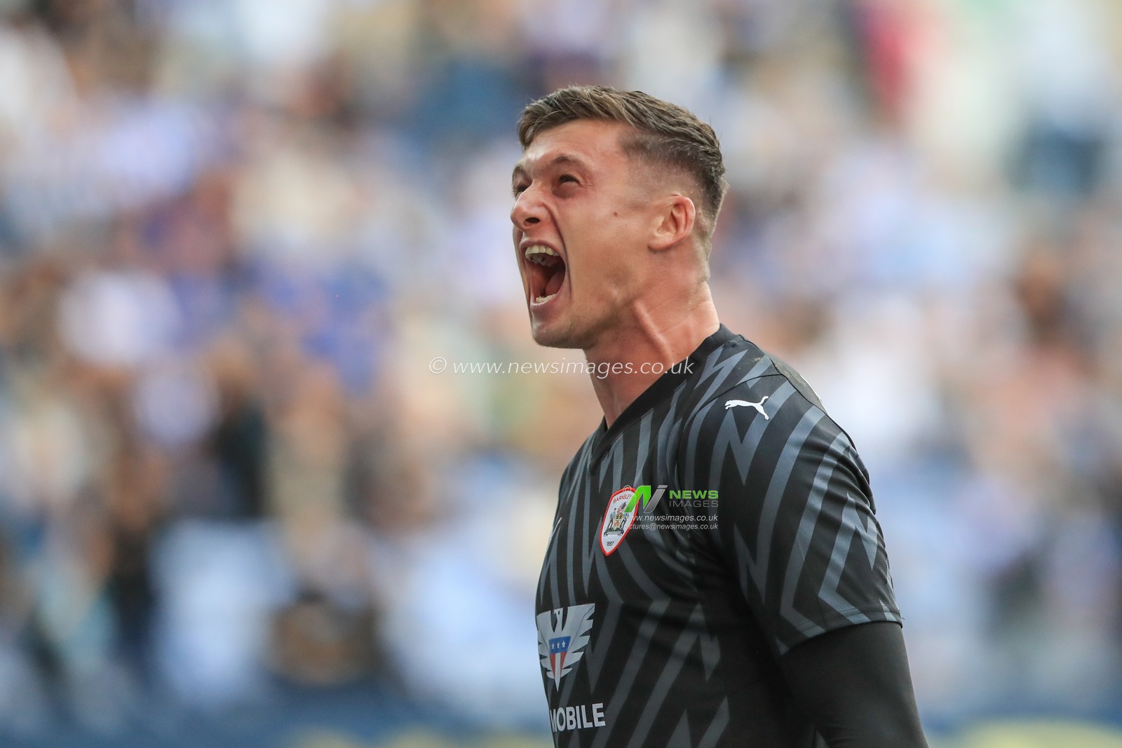 Liam Roberts #1 of Barnsley celebrates a goal scored by John Mcatee #45 of Barnsley to make it 0-2 during the Sky Bet League 1 match Wigan Athletic vs Barnsley at DW Stadium, Wigan, United Kingdom, 26th August 2023

(Photo by Alfie Cosgrove/News Images)