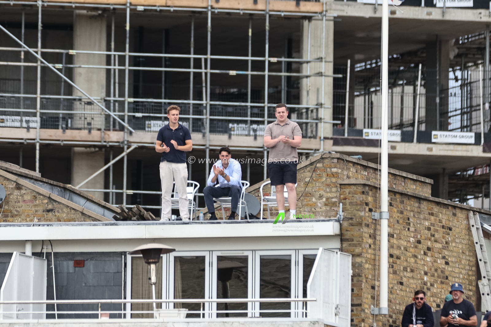 England fans high up on a rooftop applaud Joe Root of England adfter he hits a four during the 3rd Rothesay Test Match Day Three England v Sri Lanka at The Kia Oval, London, United Kingdom, 8th September 2024

(Photo by Mark Cosgrove/News Images)