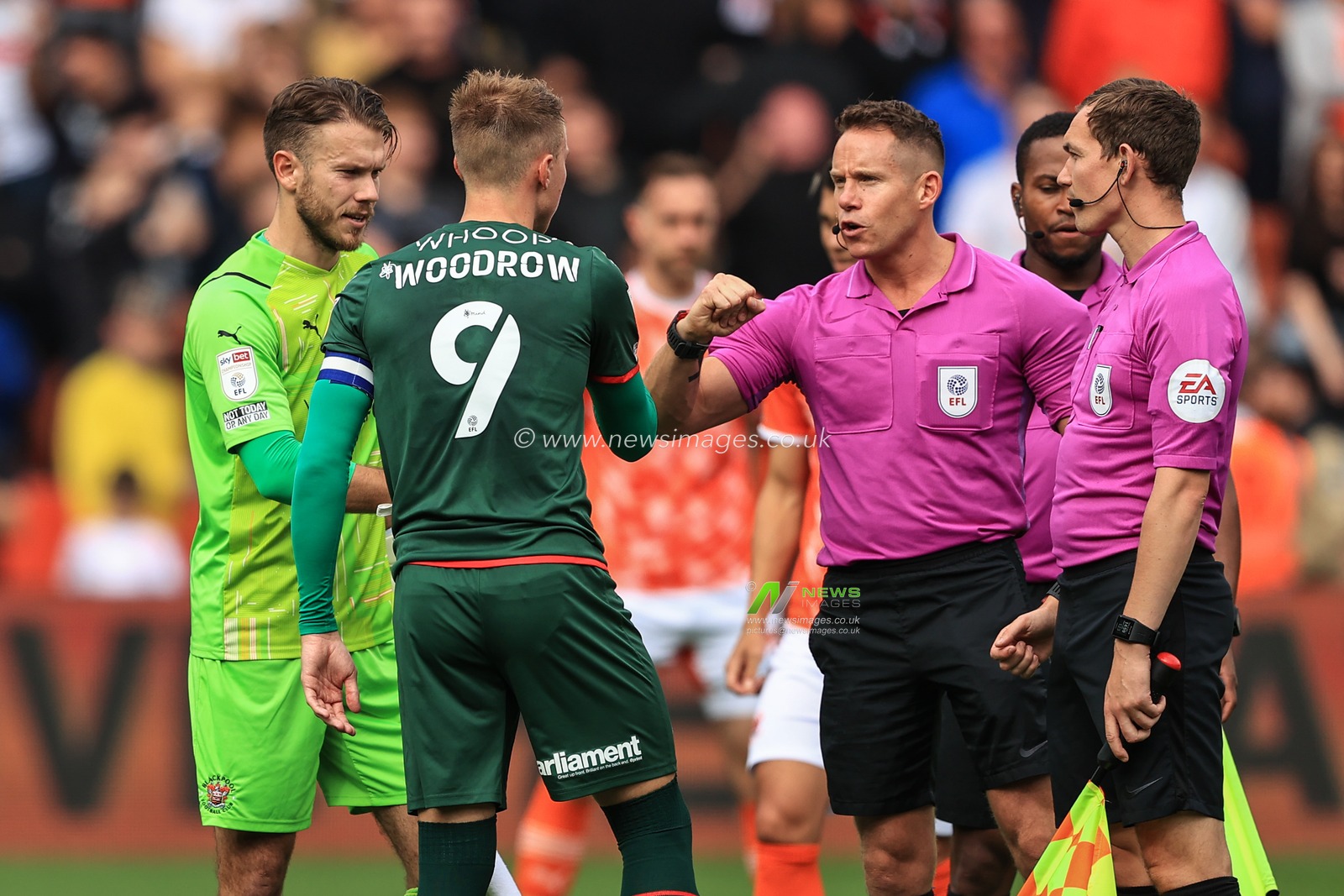 Chris Maxwell #1 of Blackpool, Referee Steve Martin and Jerry Yates #9 of Blackpool all dumb fists after the coin toss