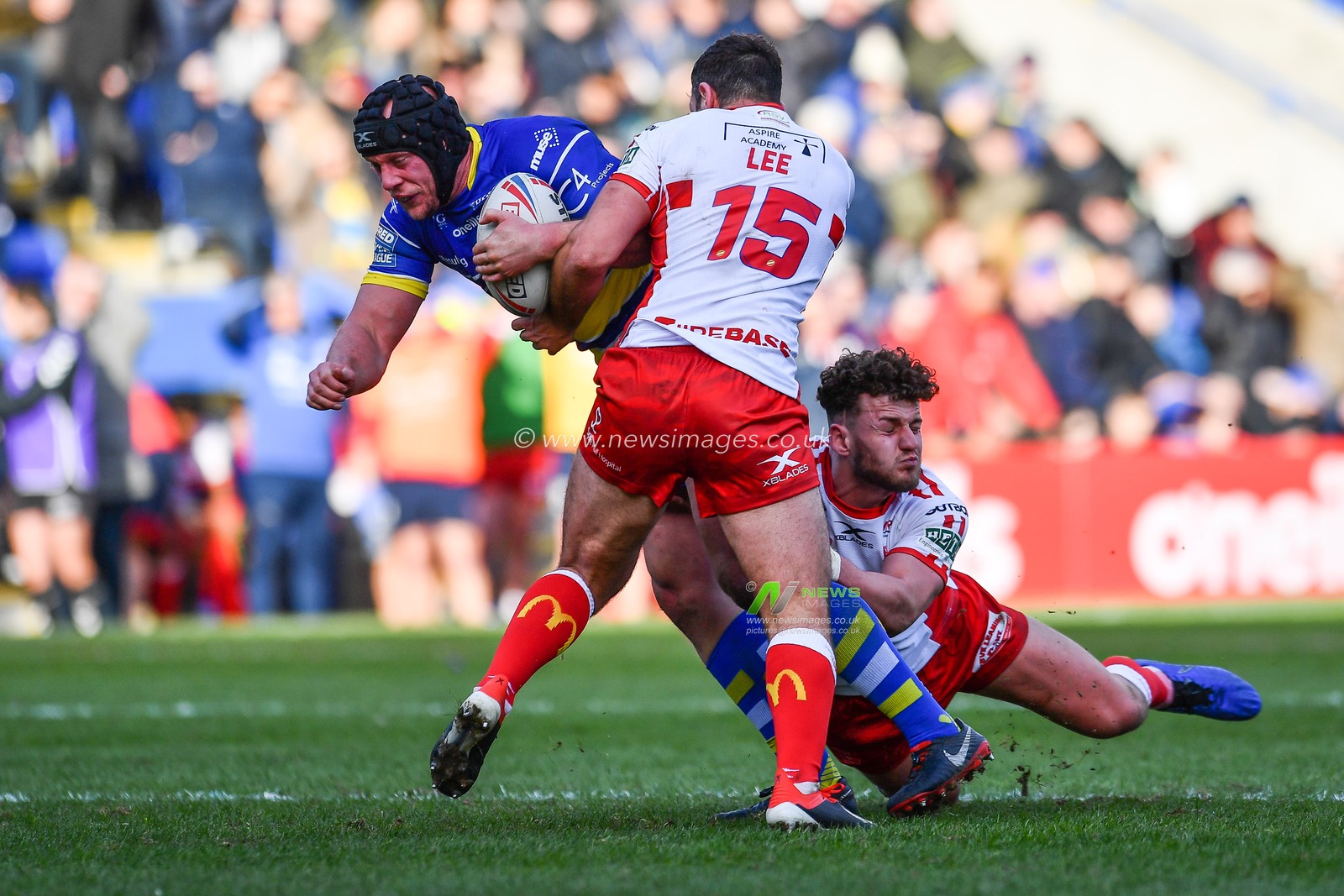 9th February 2019 , Halliwell Jones Stadium, Warrington, England;  Betfred Super League, Round 2, Warrington Wolves vs Hull KR  ; Chris Hill (8) of Warrington is tackled by Tommy Lee (15) of Hull KR 

Credit: Craig Thomas/News Images