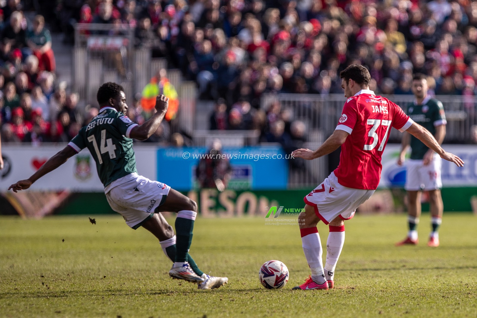 Jordi Osei-Tutu of Bolton Wanderers and Matty James of Wrexham AFC battle for possession during the Sky Bet League 1 match Wrexham vs Bolton Wanderers at SToK Cae Ras, Wrexham, United Kingdom, 1st March 2025

(Photo by Nik Mesney/News Images)