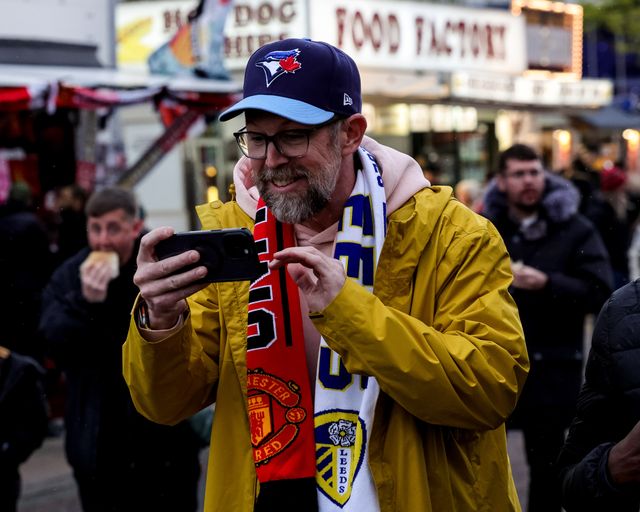 Fans make their way to the game wearing Manchester United v Leeds United scarfs during the Premier League match Manchester United vs Leeds United at Old Trafford, Manchester, United Kingdom on 13 April 2026

(Photo by Mark Cosgrove/News Images)