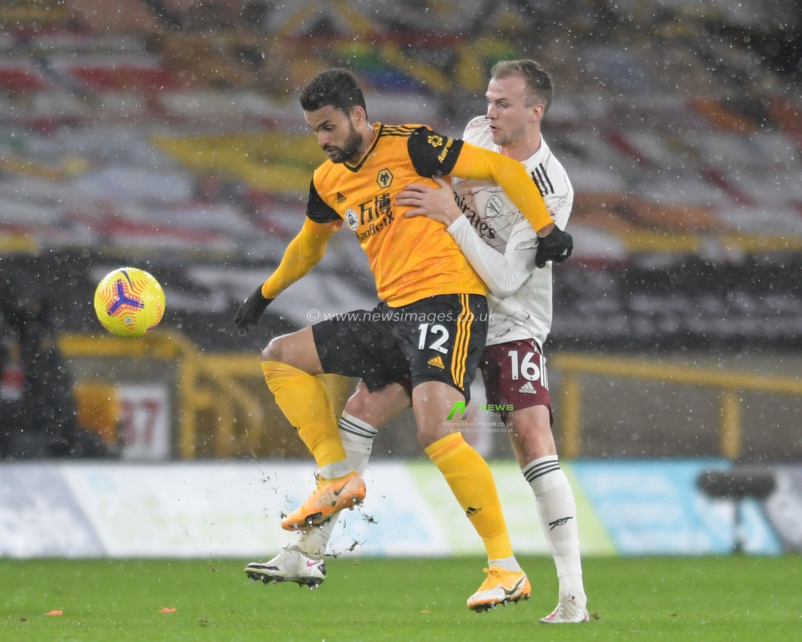 Willian Jose #12 of Wolverhampton Wanderers shields the ball from Rob Holding #16 of Arsenal