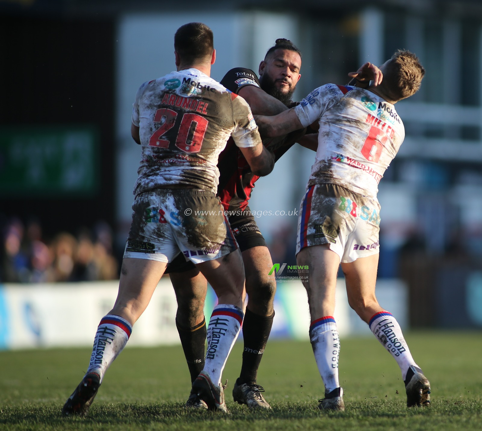 16th February 2020, Mobile Rocket Stadium, Wakefield, England; Betfred Super League, Wakefield Trinity v Warrington Wolves : Ben Murdoch-Masila (C) of Warrington Wolves tackled by Joe Arundel (L) and Jacob Miller (R) of Wakefield Trinity.