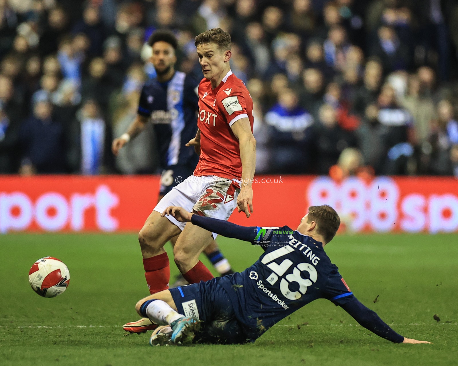Carel Eiting #48 of Huddersfield Town slides in to win the ball from Ryan Yates #22 of Nottingham Forest
