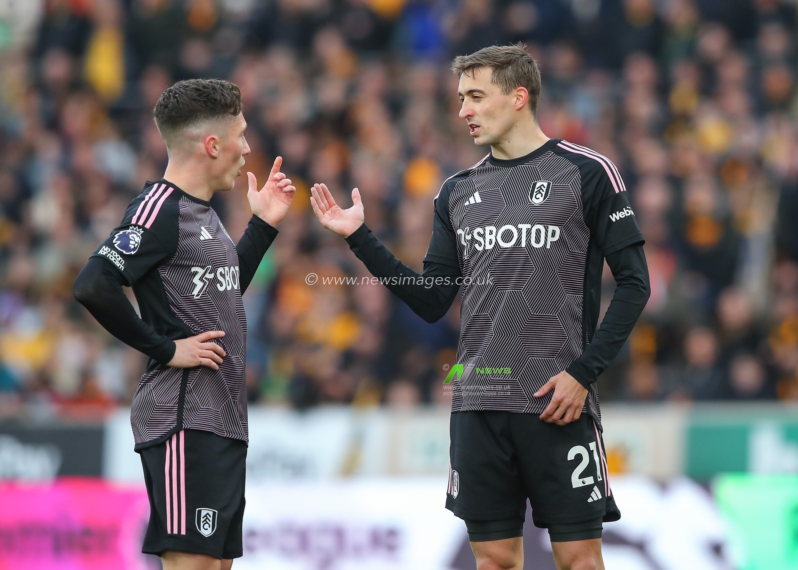 Timothy Castagne of Fulham speaks with Harry Wilson of Fulham, during the Premier League match Wolverhampton Wanderers vs Fulham at Molineux, Wolverhampton, United Kingdom, 9th March 2024

(Photo by Gareth Evans/News Images)