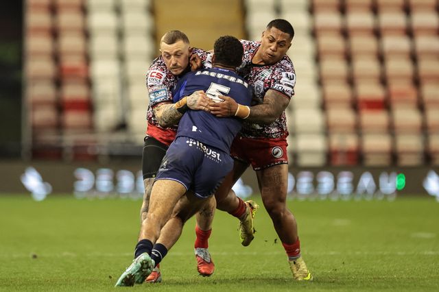 Benjamin Laguerre of Toulouse Olympique is tackled by Josh Charnley of Leigh Leopards and Tesi Niu of Leigh Leopards during the Betfred Super League round 6 match Leigh Leopards vs Toulouse at Leigh Sports Village, Leigh, United Kingdom on 28 March 2026

(Photo by Mark Cosgrove/News Images)