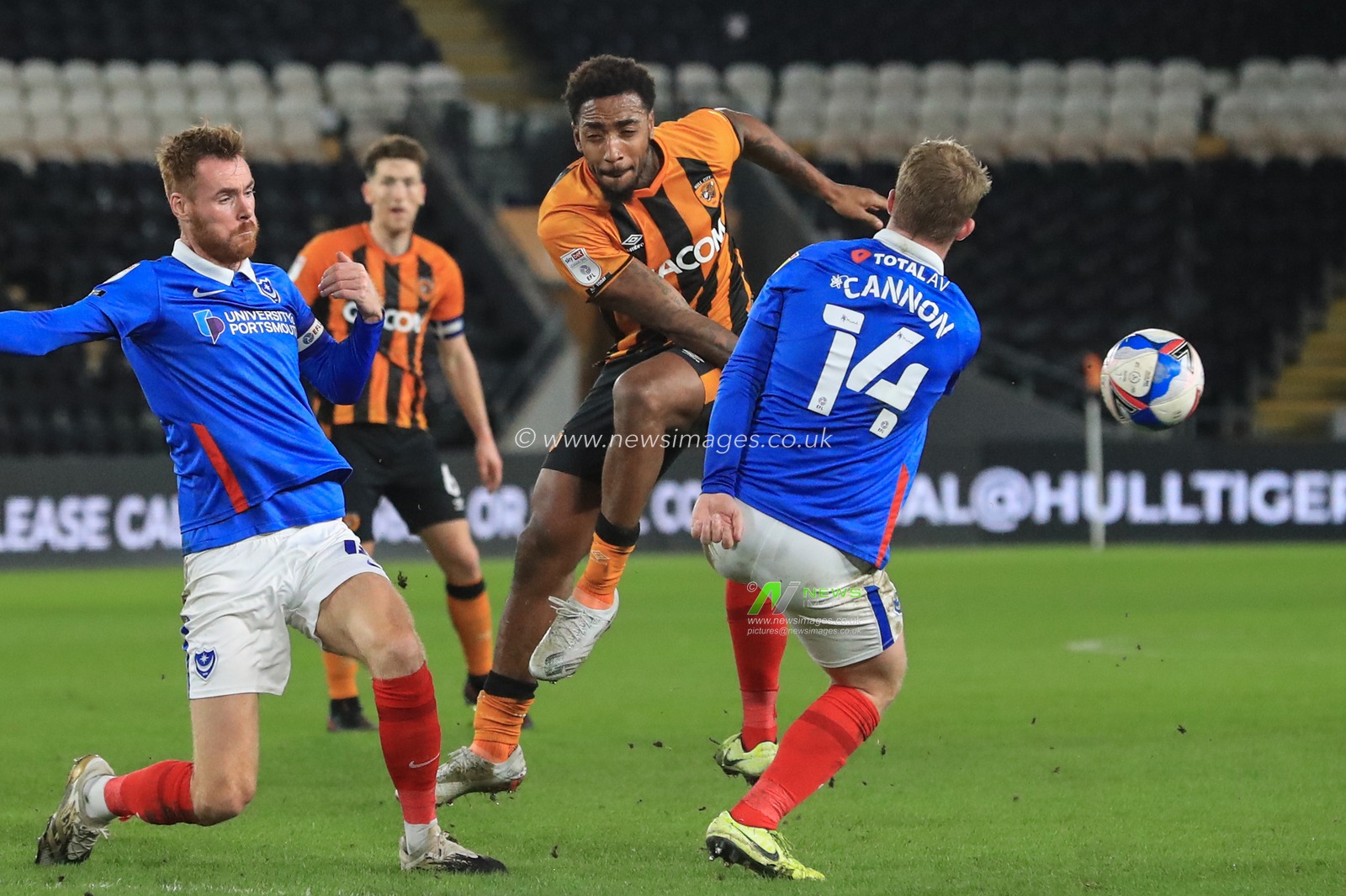 Andy Cannon #14 of Portsmouth deflects Mallik Wilks #7 of Hull Cityâ€™s shot on goal