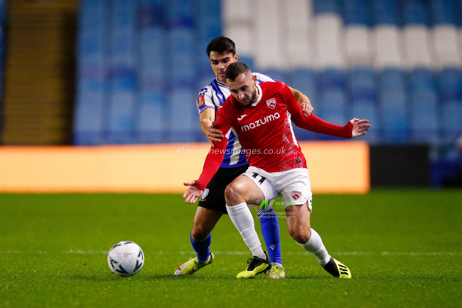 Reece James #33 of Sheffield Wednesday and Dylan Connolly #11 of Morecambe during the Emirates FA Cup match Sheffield Wednesday vs Morecambe at Hillsborough, Sheffield, United Kingdom, 4th November 2022

(Photo by Ben Early/News Images)