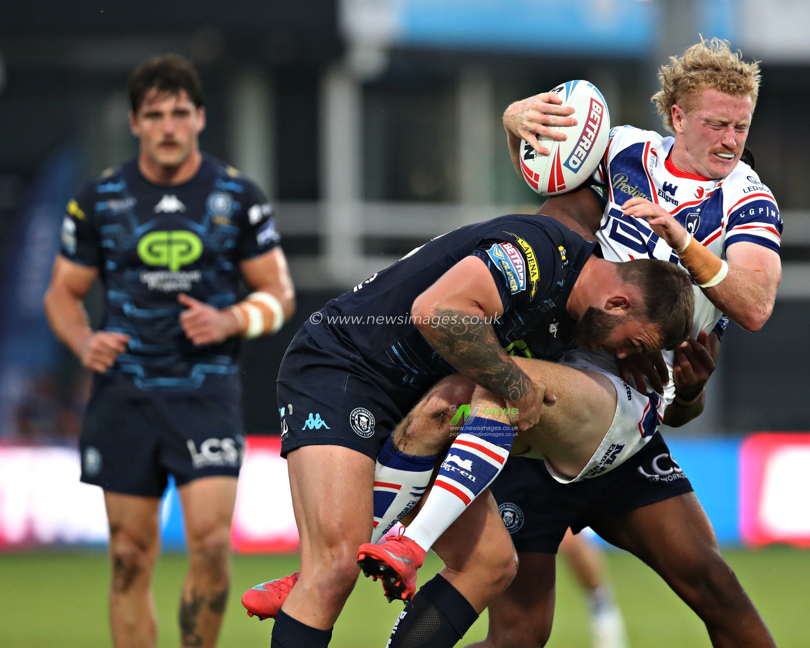 Kaide Ellis of Wigan Warriors tackles Lachlan Walmsley of Wakefield Trinity during the Betfred Super League round 15 match Wakefield Trinity vs Wigan Warriors at DIY Kitchens Stadium, Wakefield, United Kingdom, 20th June 2025(Photo by Sam Eaden/News Images)