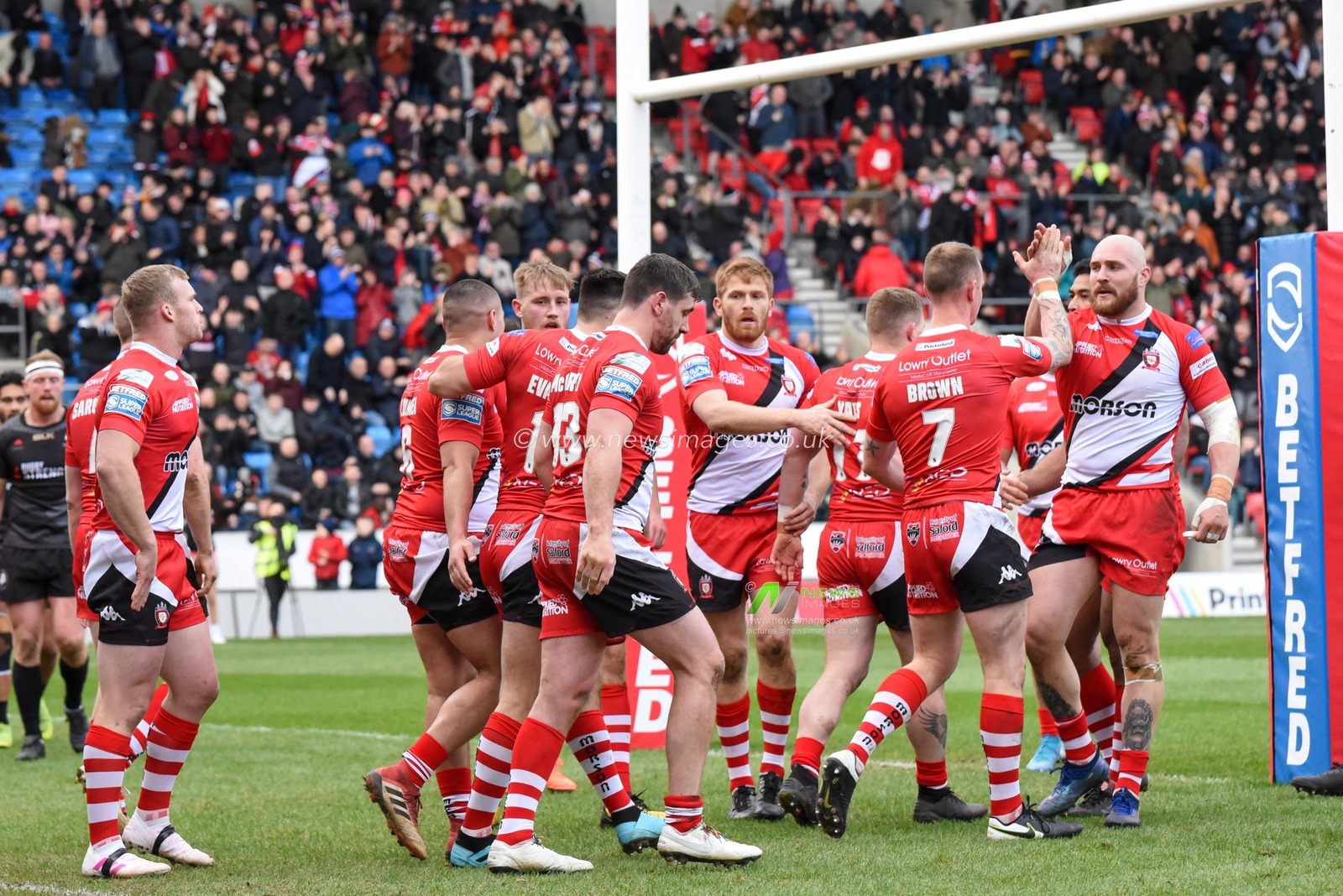 8th February 2020, AJ Bell Stadium, Eccles, England; Betfred Super League, Salford Red Devils v Toronto Wolfpack : The Salford Red Devils players celebrate with try scorer Kevin Brown (31)
