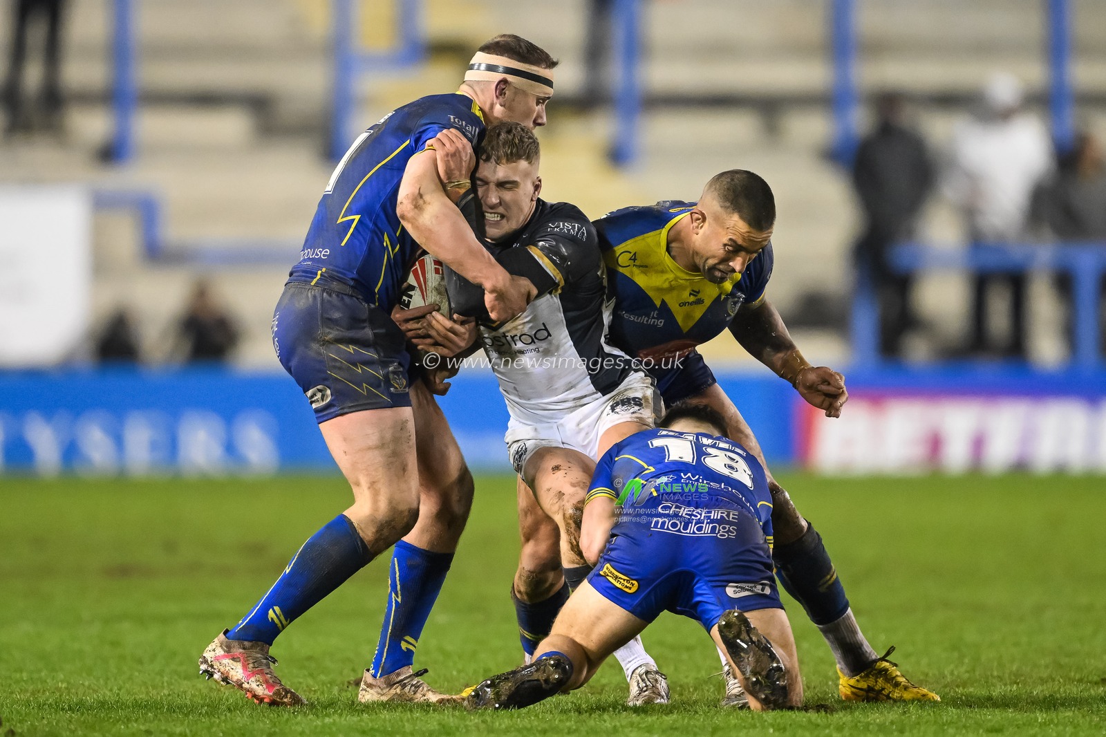 Charlie Severs Hull FC is tackled by Paul Vaughan of Warrington Wolves Ben Currie of Warrington Wolves and Leon Hayes of Warrington Wolves during the Betfred Super League Round 2 match Warrington Wolves vs Hull FC at Halliwell Jones Stadium, Warrington, United Kingdom, 23rd February 2024

(Photo by Craig Thomas/News Images)