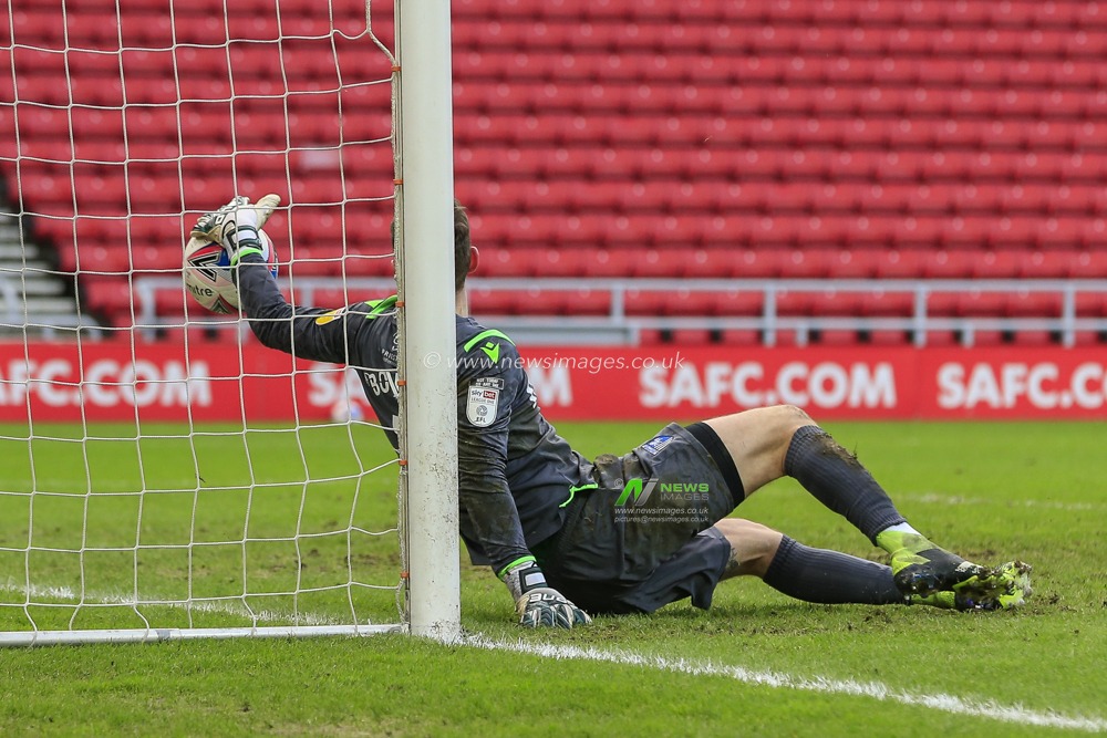 Jack Bonham #1 of Gillingham tries to keep his penalty save from bouncing into the net after he saved a penalty kick from Grant Leadbitter #23 of Sunderland