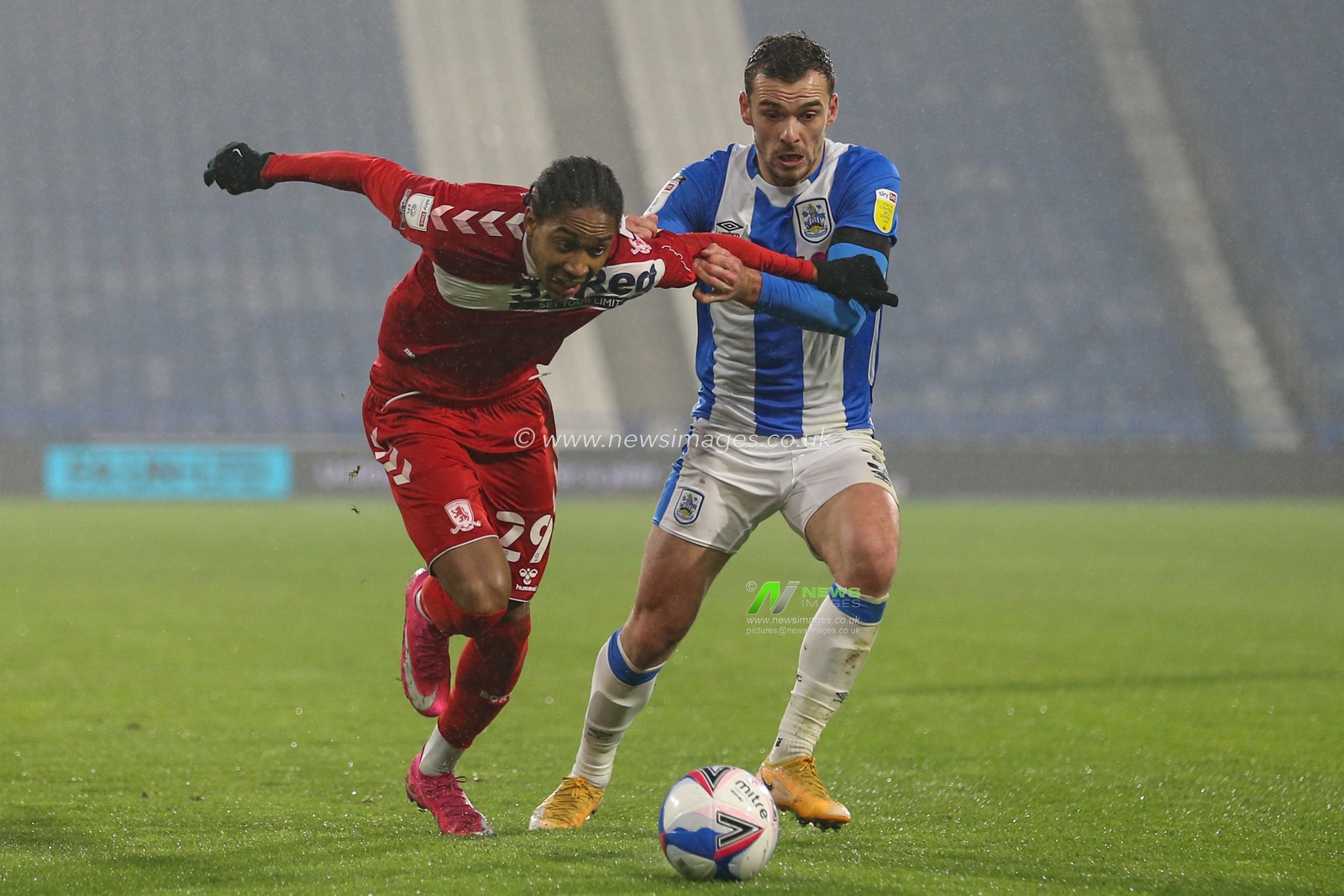 Djed Spence #29 of Middlesbrough takes the ball past Harry Toffolo #3 of Huddersfield Town