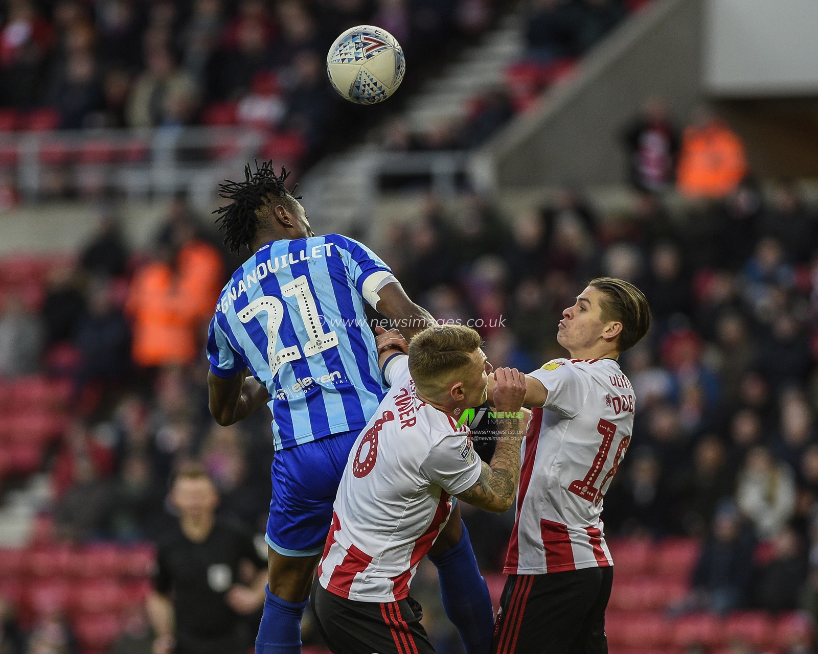 14th December 2019, Stadium Of Light, Sunderland, England; Sky Bet League 1, Sunderland v Blackpool : Armand Gnanduillet (21) of Blackpool in an aerial challenge with Max Power (6) of Sunderland and George Dobson (18) of Sunderland

Credit: Iam Burn/News Images