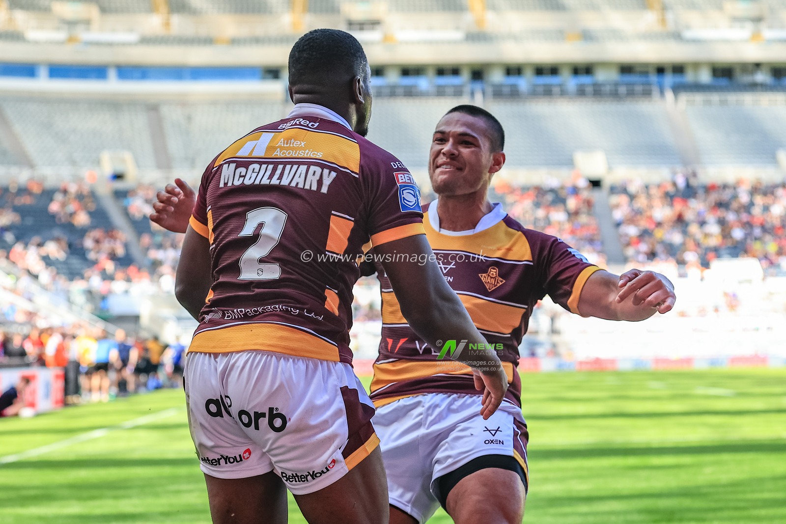 Jermaine McGillvary #2 of Huddersfield Giants celebrates his try with Tui Lolohea #6 of Huddersfield Giants