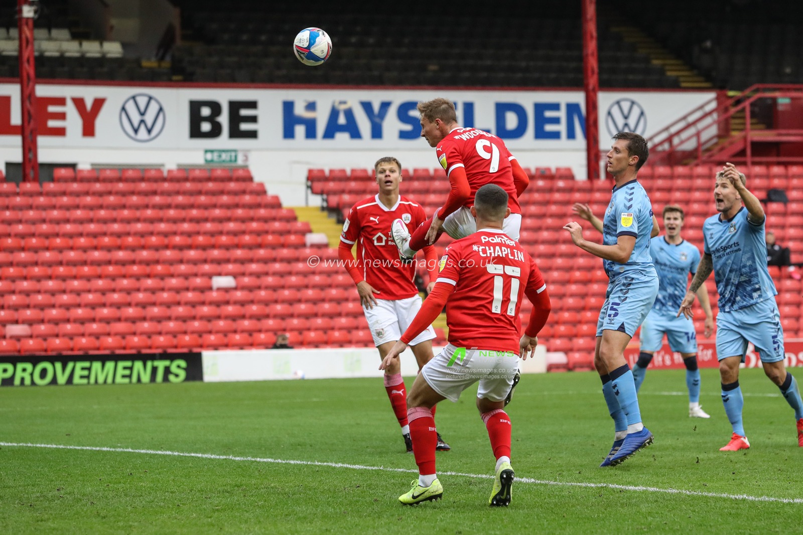 Cauley Woodrow (9) of Barnsley heads on goal, close effort