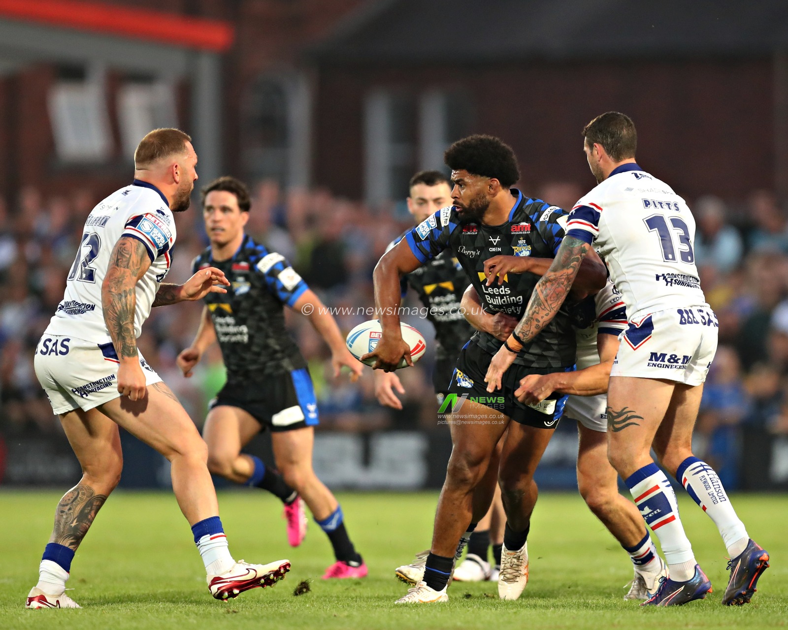 Kallum Watkins of Leeds Rhinos offloads the ball during the Betfred Super League round 20 match Wakefield Trinity vs Leeds Rhinos at DIY Kitchens Stadium, Wakefield, United Kingdom, 24th July 2025(Photo by Sam Eaden/News Images)