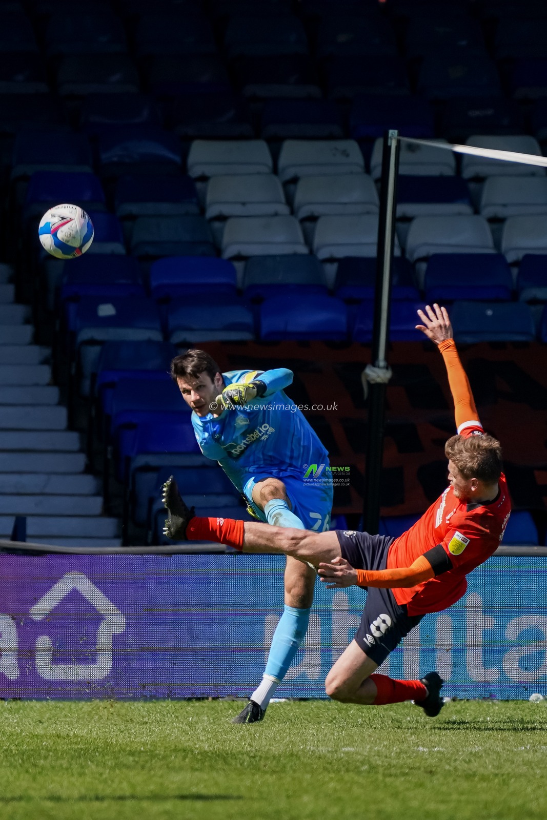 Luke Berry #8 of Luton Town tries to intercept Daniel Bachmann #26 of Watford goal kick
