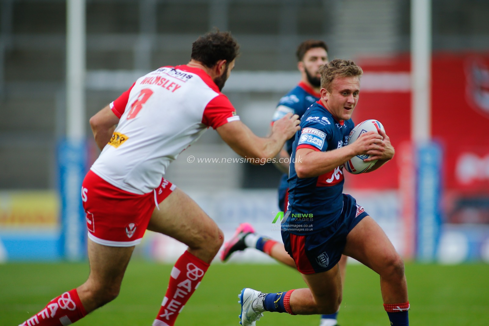 Jez Litten (18) of Hull KR tackled by Alex Walmsley (8) of St Helens.