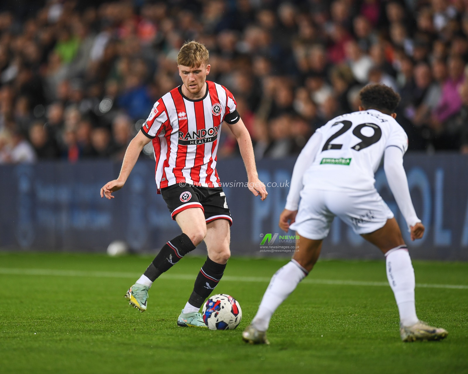 Tommy Doyle #22 of Sheffield United  Under pressure from Matthew Sorinola #29 of Swansea City during the Sky Bet Championship match Swansea City vs Sheffield United at Swansea.com Stadium, Swansea, United Kingdom, 13th September 2022

(Photo by Mike Jones/News Images)
